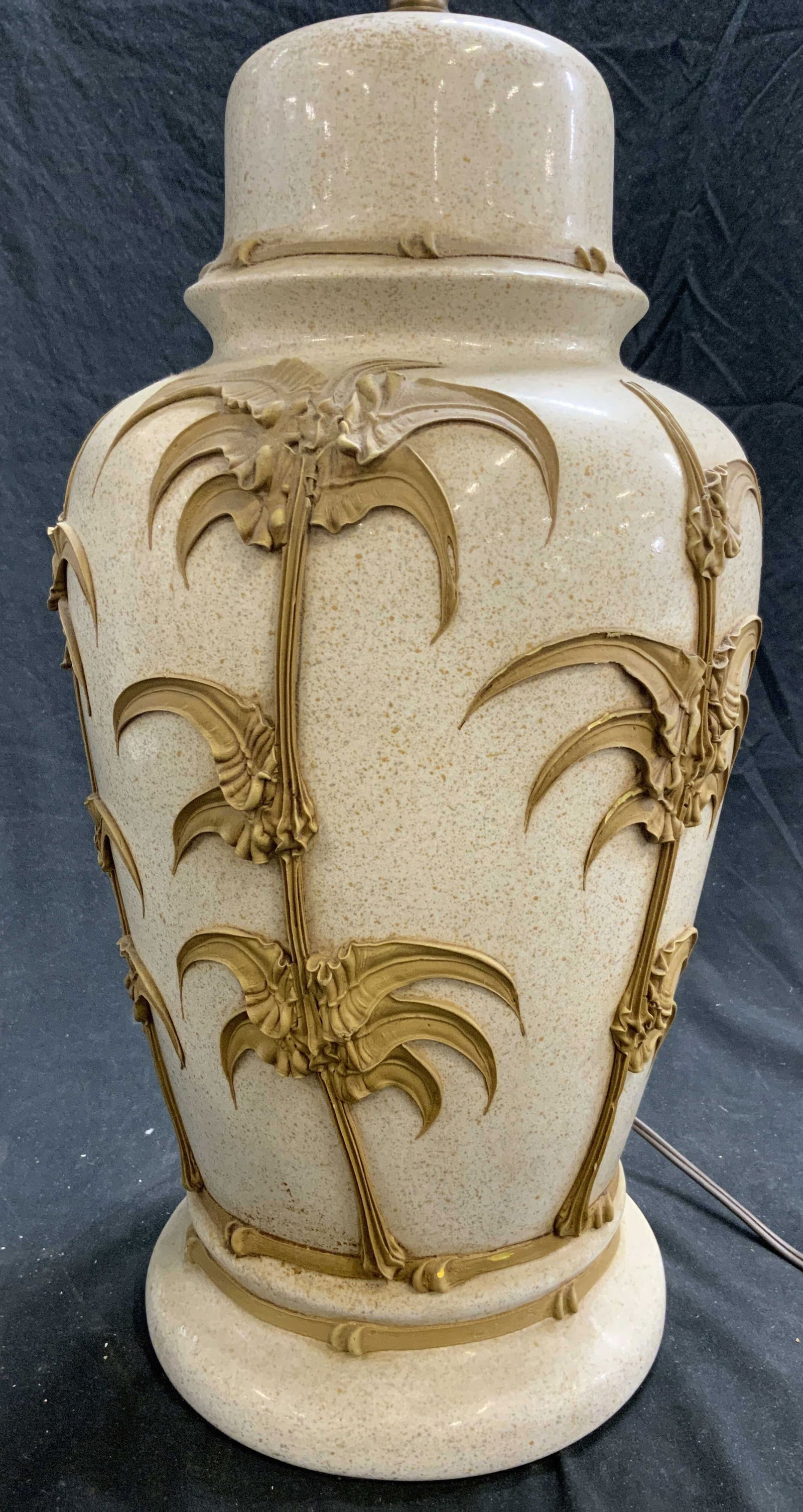 Vntg Ceramic Hollywood Regency Bamboo Detail Lamp: Lamp is vintage and ceramic. Piece is Hollywood Regency style with icing style painted beige toned bamboo detail. Lamp is cream toned with speckled detail. Lamp includes harp. Piece measures approxima