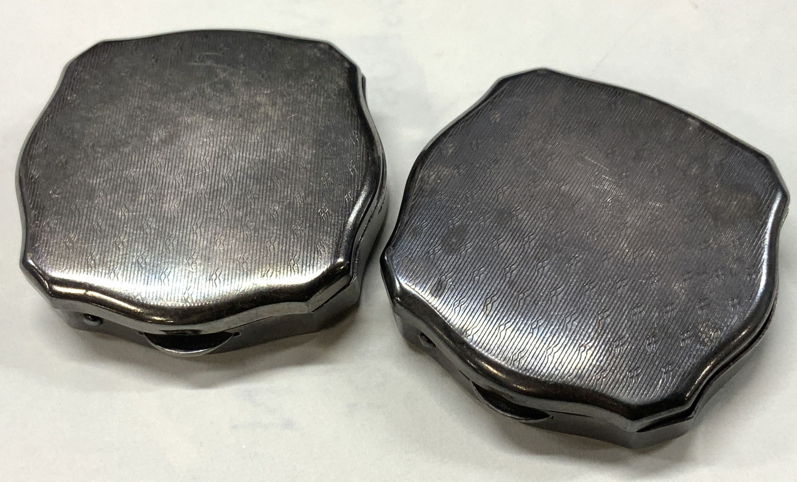 Pr Sterling Silver Pill Boxes, Denmark: Pair of vintage sterling silver pill boxes with stamps marked Denmark on sides with hinge and latches Approx 2 x 2 inches Moderate discoloration to sterling due to age and use. Total weight of sterlin