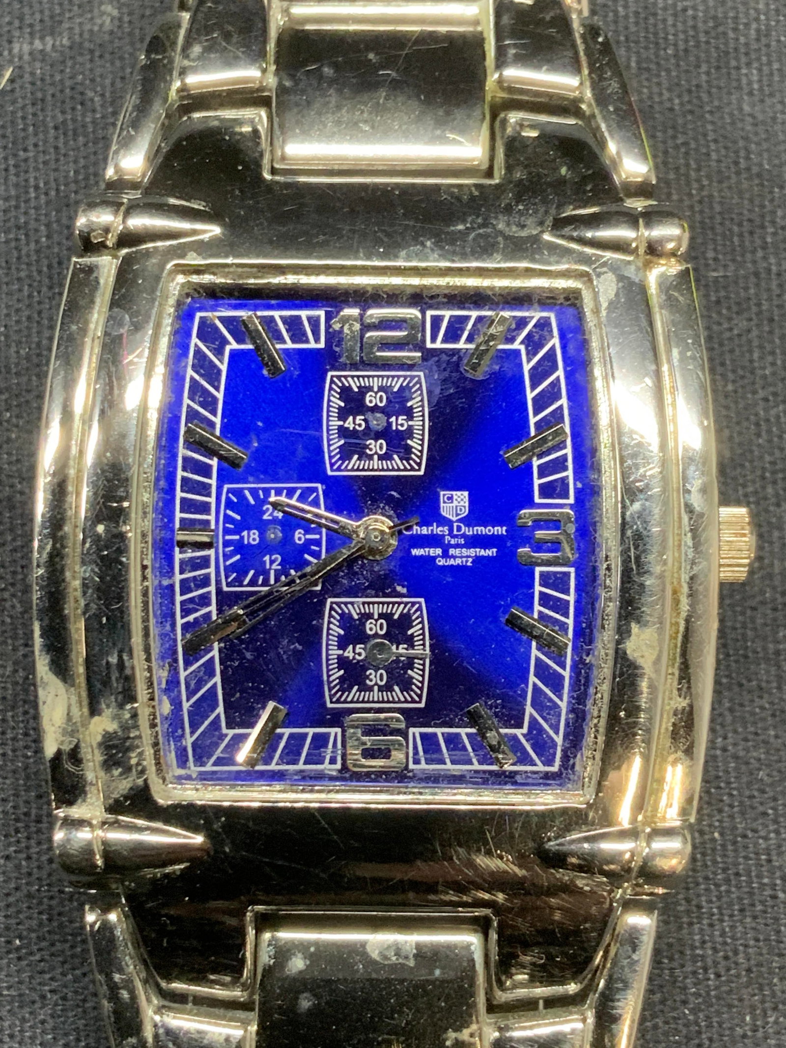 Charles Dumont Paris Stainless Steel Watch: Charles Dumont Paris stainless steel watch and with blue watch face. Signed on face. Wrist measures approx. 2.5 inches wide. Not tested for function. Some surface wear including scratching observed. E