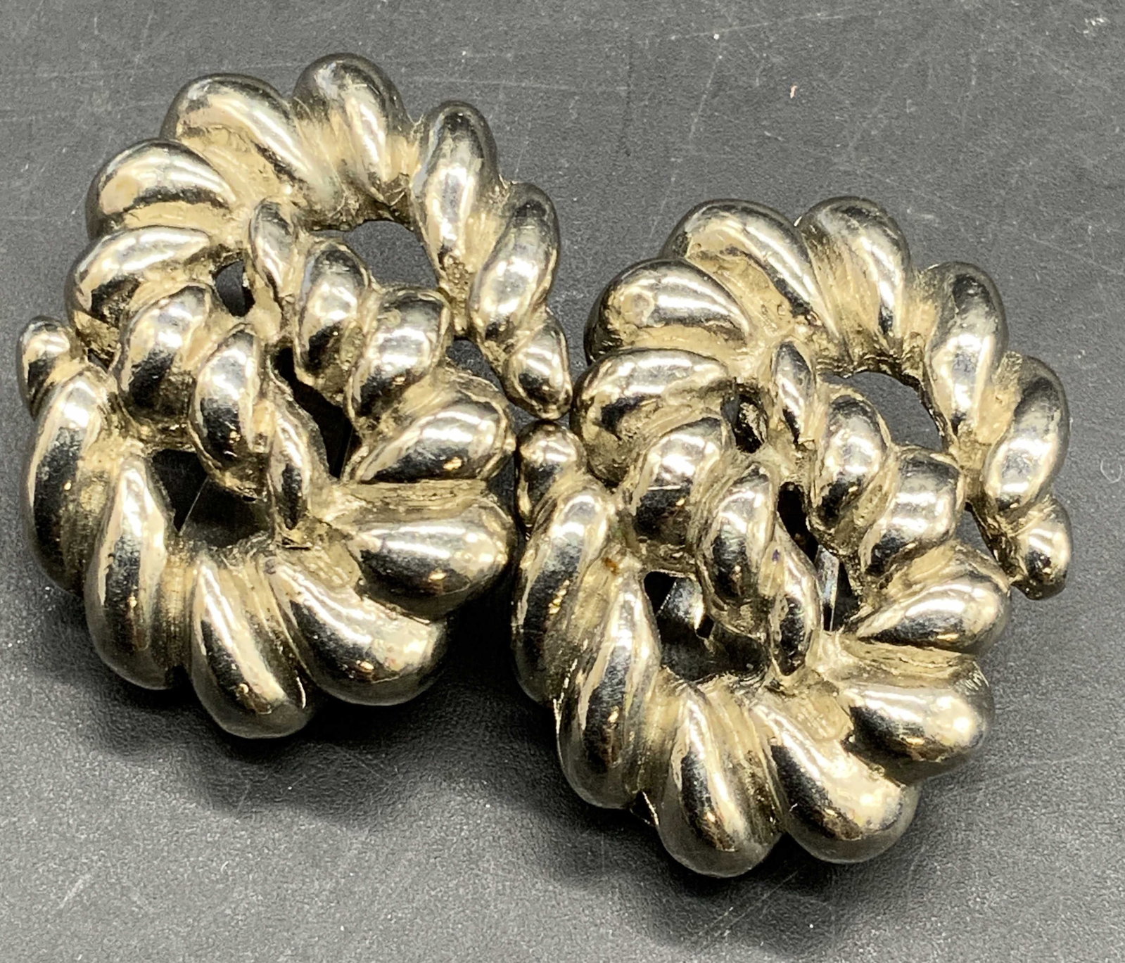 Vtg Yves Saint Laurent Rope S Swirl Clip Earrings: Vintage Yves Saint Laurent S form swirl rope design clip on earrings. Crafted from silver tone metal. Marked YSL to reverse. Measures approx, 1.25L x 1W in. Some surface wear consistent with age, use,