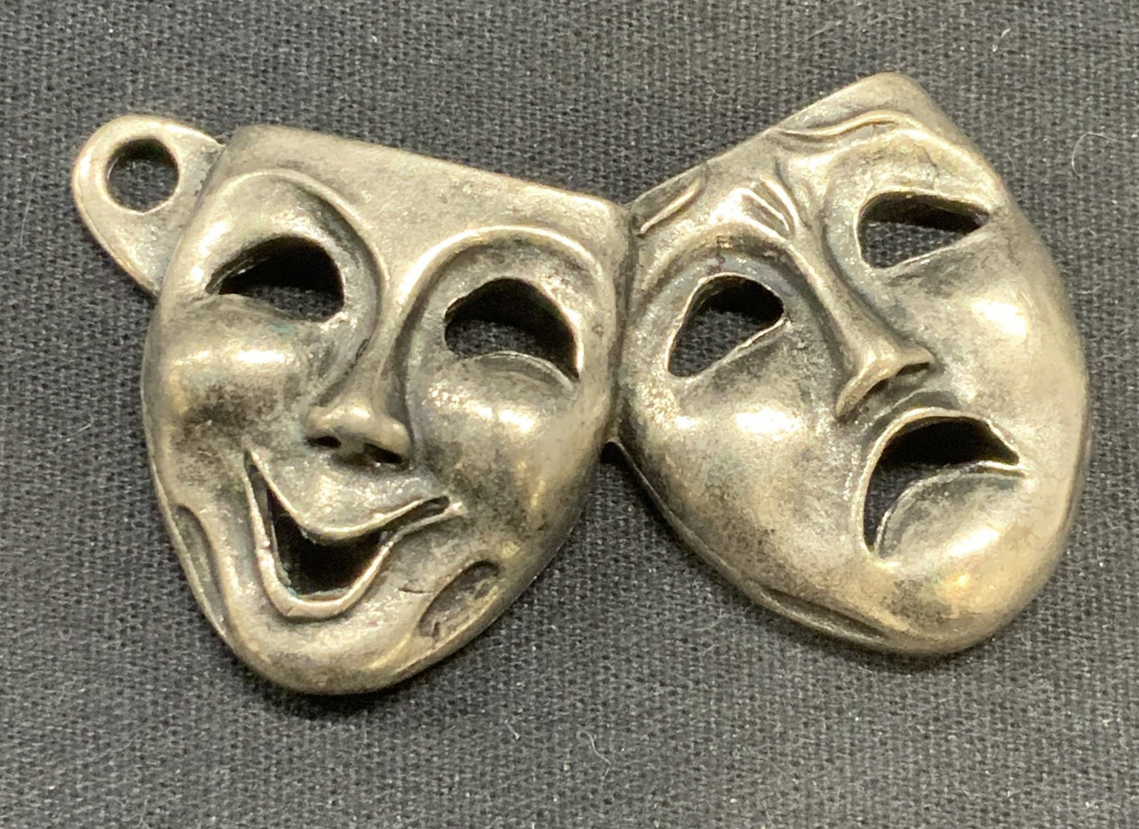Vintage Silver Tone Venetian Mask Pendant: Vintage silver tone Venetian mask motif pendant. Measures approx. 2.25 x 1.25 inches. Some surface wear including scratching observed. Estate jewelry, costume jewelry, cocktail jewelry, fashion jewelr