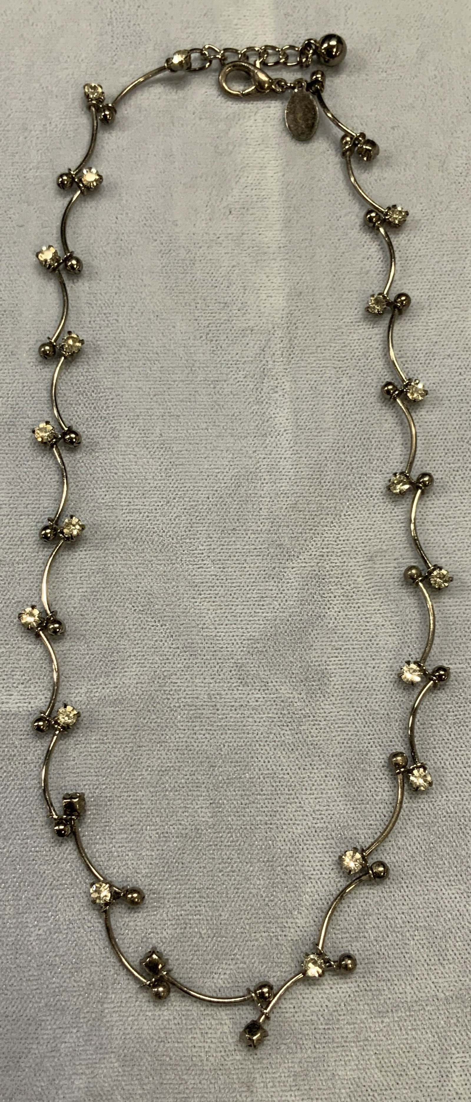 Express Silver Tone Crystal Choker Necklace: Express silver tone crystal decorated choker necklace. Signed on hang tag. Drop length approx. 7 inches. Some surface wear including scratching observed. Estate jewelry, costume jewelry, cocktail jewe