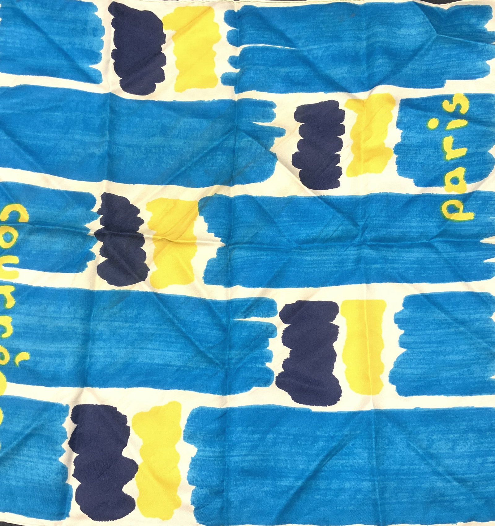 Hand Rolled Silk Scarf PARIS COURREGES, Switz: 18 x 18.5 in. Silk scarf with turquoise, navy, and yellow painted patched of color. One side reads PARIS, the opposite side reads COURREGES Sewn label attached - Made In Switzerland. Blemishing. Needs