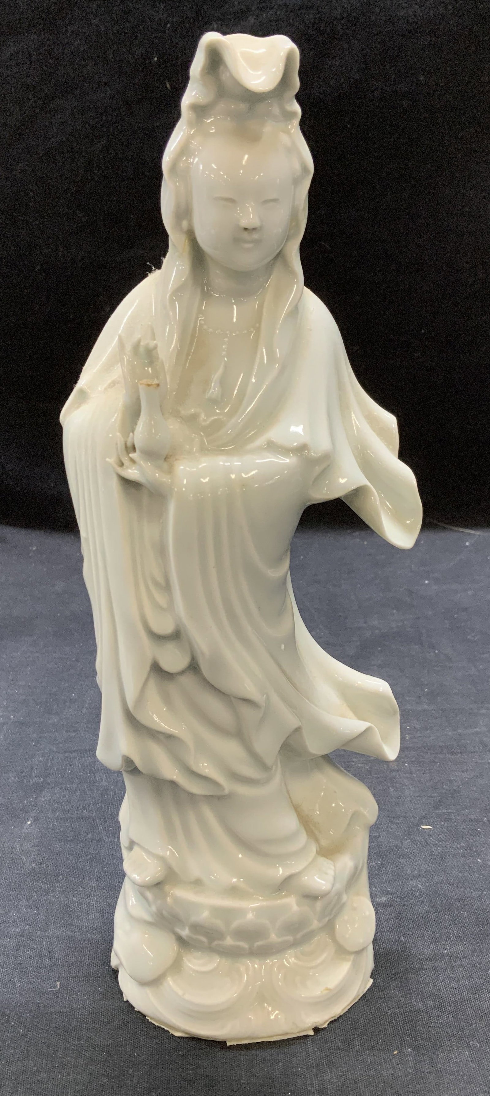 Signed White Porcelain Guanyin Figural: Signed white porcelain Guanyin Figural. Signed to underside. Measures approx. 3.75 inches wide and 10.5 inches tall. Some surface wear including hairline crack and small ship observed. Guanyin, Quan y