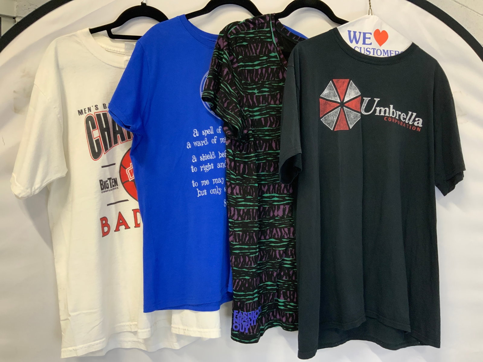 Lot 4 Vtg & Sport Cotton T Shirts: Lot of 4 t shirts, vintage and pop culture and sports. 1 mens basketball tournament Champions Badger shirt. 1 Vtg patterned purple and green shirt made in Peru. 1 blue toned shirt with a talisman on t