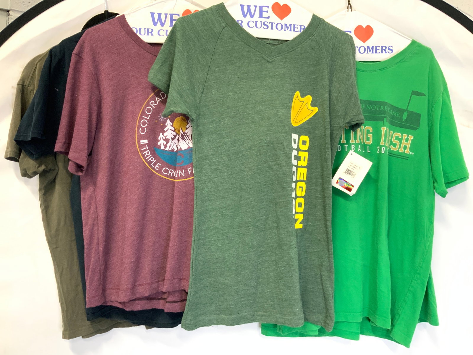 6 Cotton Graphic Tshirts, Sports & More: Lot of 6 cotton medium size t shirts with graphics, 2 marked The fighting Irish, Notre dame. 1 marked Oregon Ducks NWT, reading collegiate Licensed Product. 1 Colorado 4th of July shirt. 1 olive green