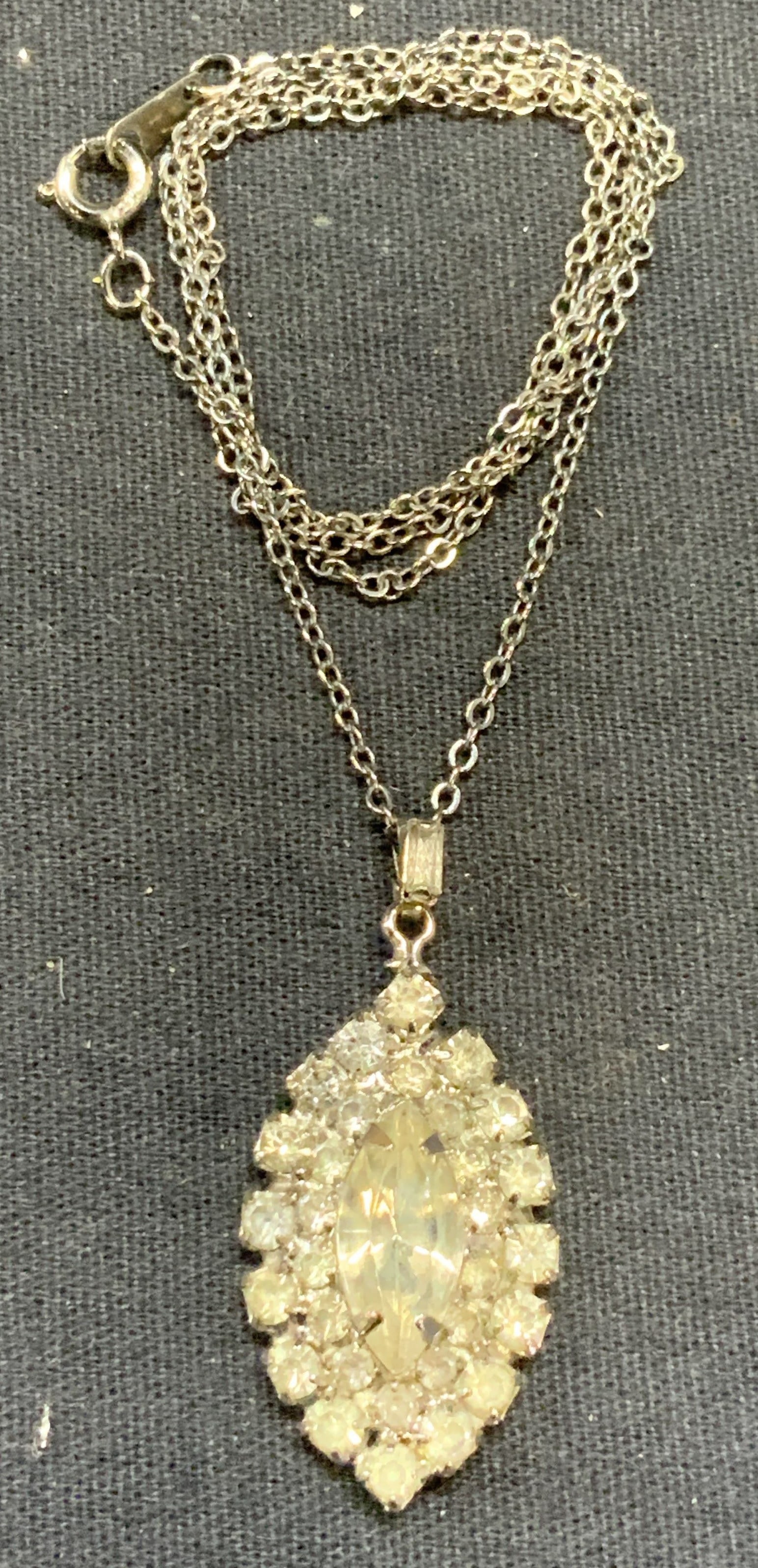 Vintage Silver Tone Crystal pendant Necklace: Vintage silver tone necklace with crystal pendant. Drop length approx. 9 inches. Pendant measures approx. 1.25 x .75 inches. Some surface wear including scratching observed. Estate jewelry, costume je