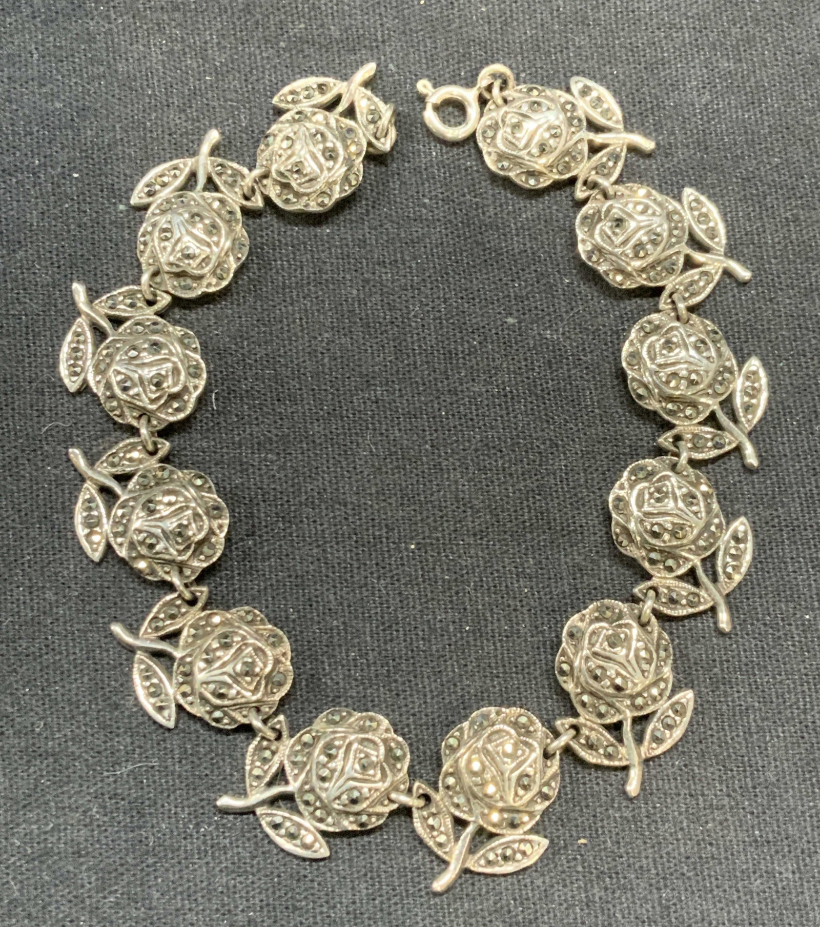 Vintage Sterling Silver Marcasite Flower Bracelet: Vintage sterling and Marcasite bracelet with flower motif. Marked sterling. Measures approx. 7.5 inches long. Total weight 21.6 grams. Some surface wear including scratching observed. Estate jewelry, 