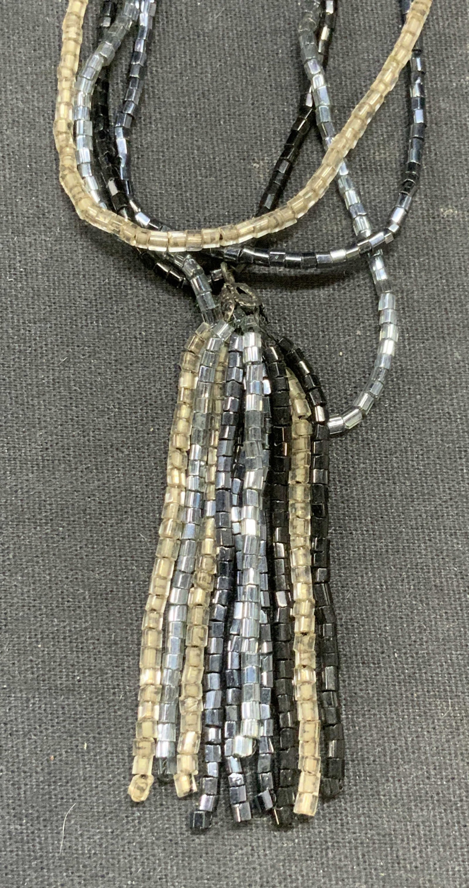 Blue, Black, Silver Tn Beaded Pendant Necklace: Blue, black, and silver tone seed beaded pendant necklace. Drop length approx. 8.5 inches. Pendant length approx. 2.5 inches. Some surface wear including scratching observed. Estate jewelry, costume j