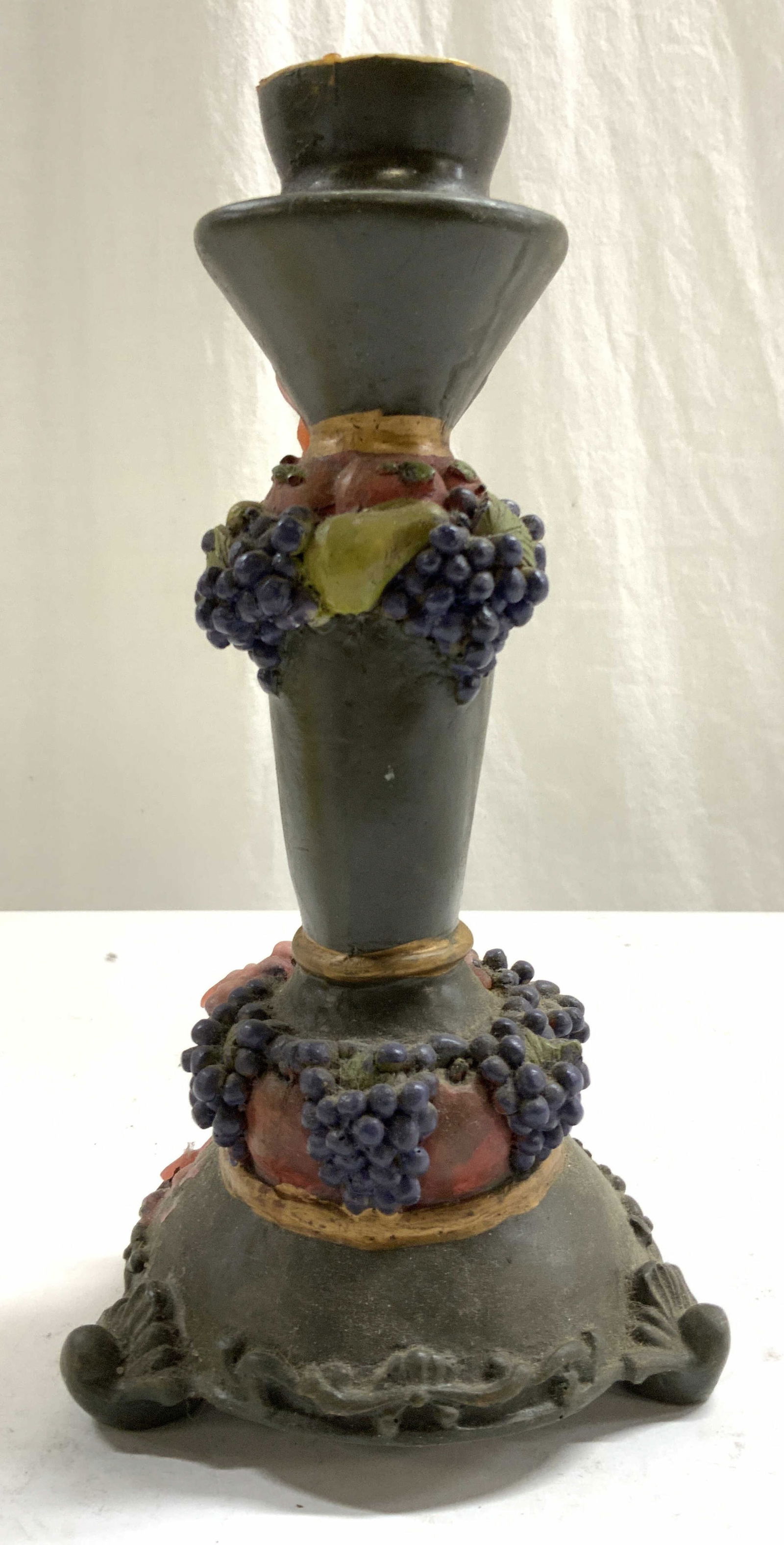 Vintage Footed Resin Candlestick W Fruit Detail: Candlestick is vintage. Piece appears to be Resin. Candlestick has 3 feet. Piece has grape, pear & leaf detail. Candlestick measures approx 8.5 inches tall 4.5 Inches wide. Candlestick, resin candlest