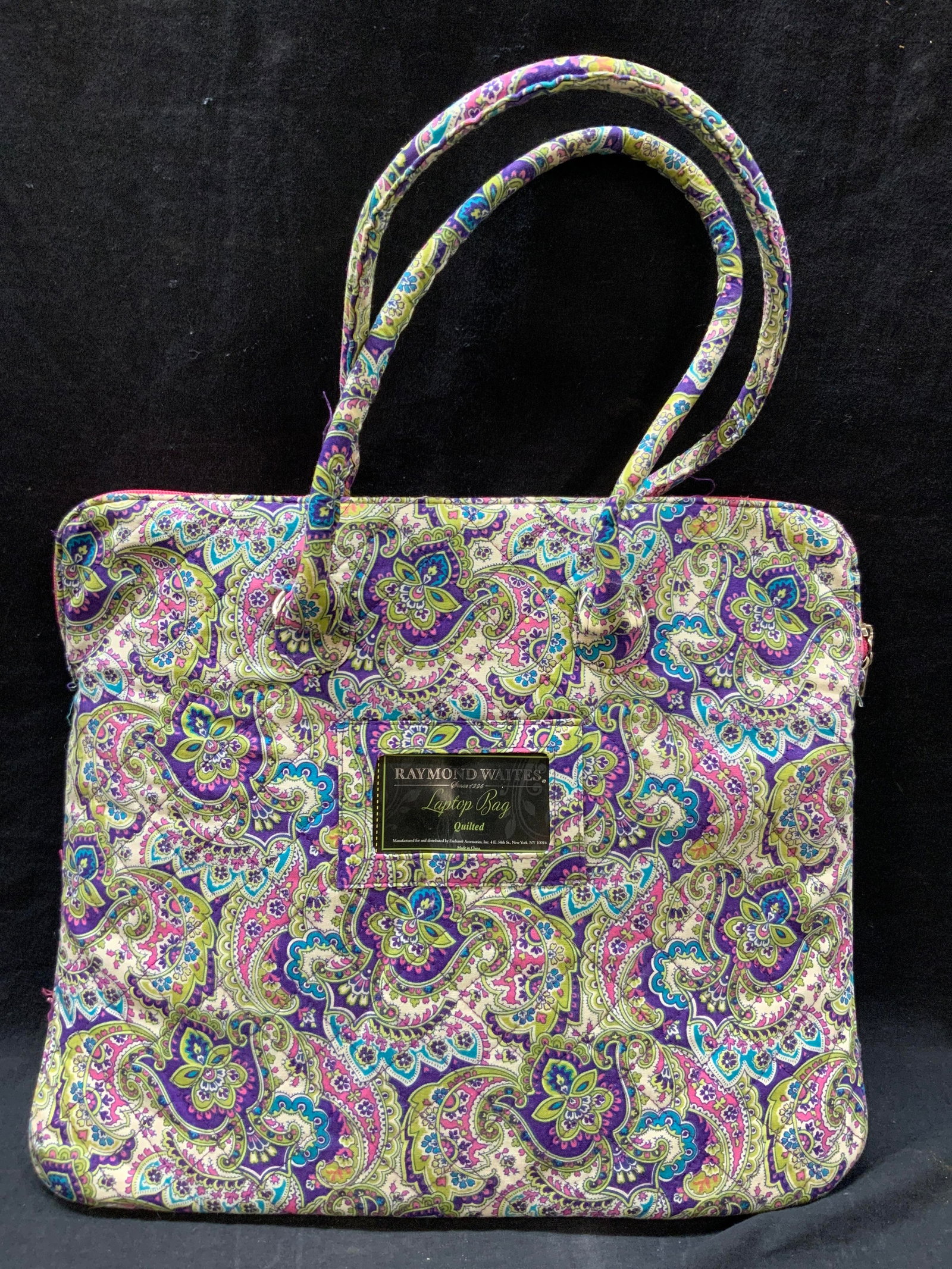 Raymond Waites quilted Laptop Bag: Marked on tag Raymond Waites, quilted laptop bag with paisley designs in green and purple, and comes with a purple coin purse. Approx 13 x 15 x 1 inches. Minor wearing to materials. Top handle measure