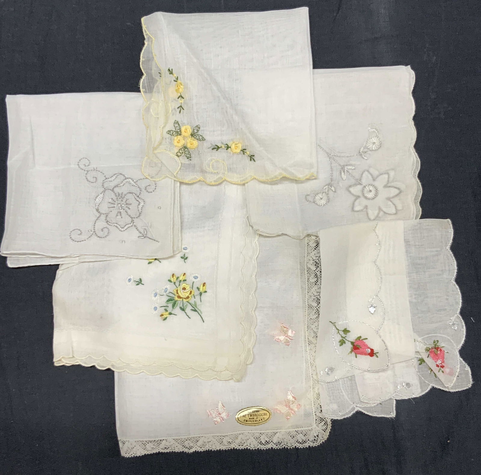 Lot 6 Embroidered Linen & Cotton Handkerchiefs: Lot of 6 vintage off white cotton and linen made handkerchiefs with floral embroidery on corners. Some with lace edges and others many with pink roses, yellow daisies and pink butterflies. Largest han