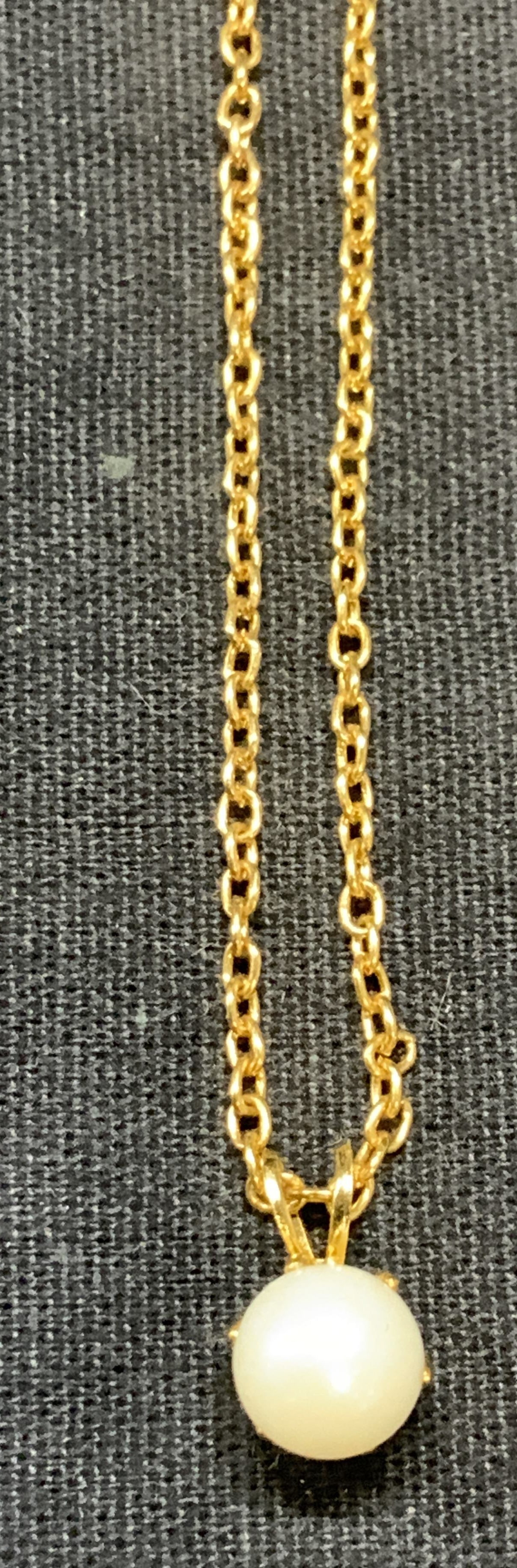 Gold Tone Faux Pearl Pendant Necklace: Gold tone pendant necklace with faux Pearl. Drop length approx. 8.75 inches. Some surface wear including scratching observed. Estate jewelry, costume jewelry, cocktail jewelry, fashion jewelry, access
