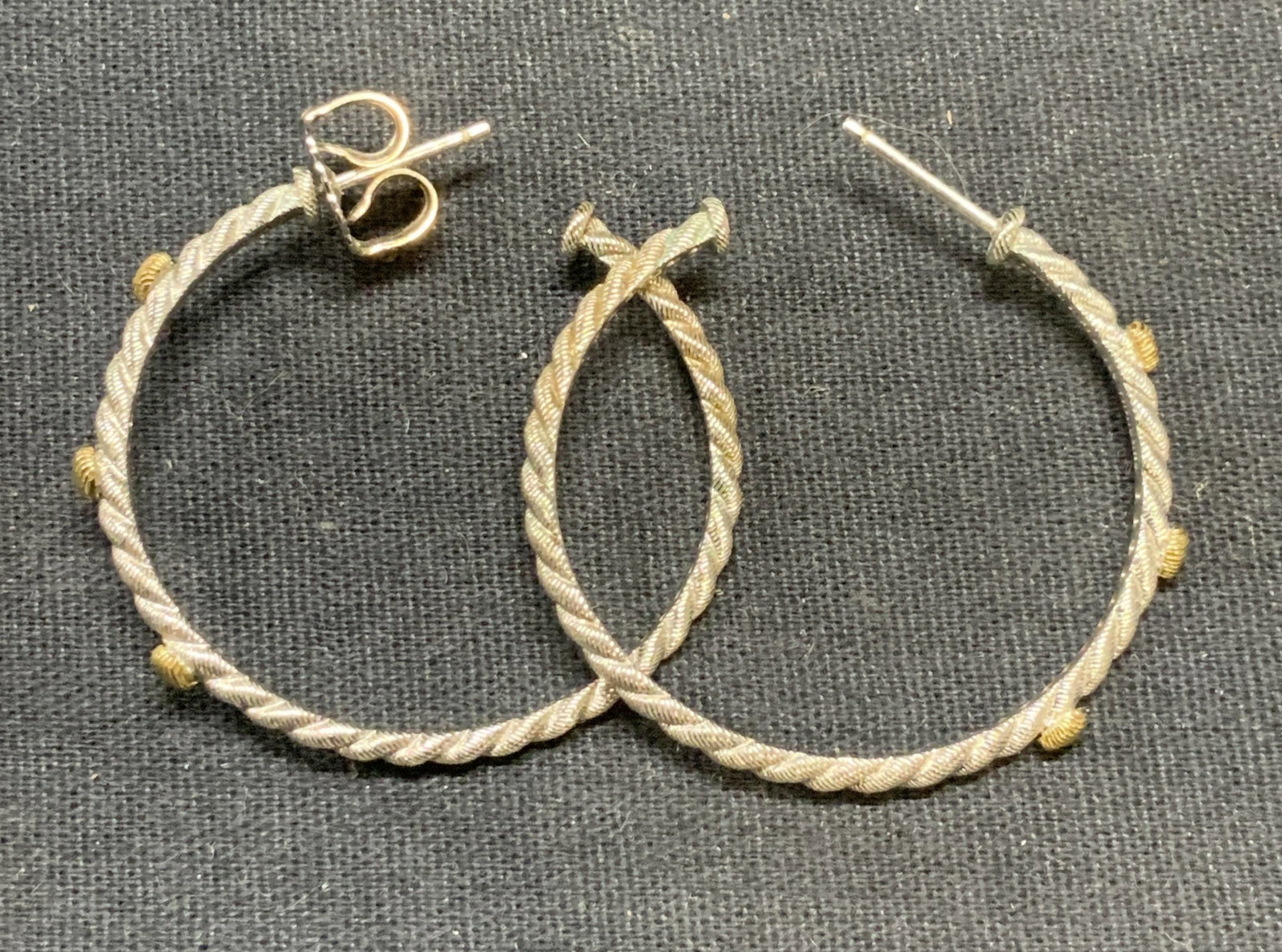 Sterling Silver Gold Plated Hoop Earrings: Sterling silver and gold plated hoop earrings with embossed cable motif. Measure approx. 1.25 inches wide. Total weight .18 ozt. Test for sterling using Puritest kit. Some surface wear including scrat