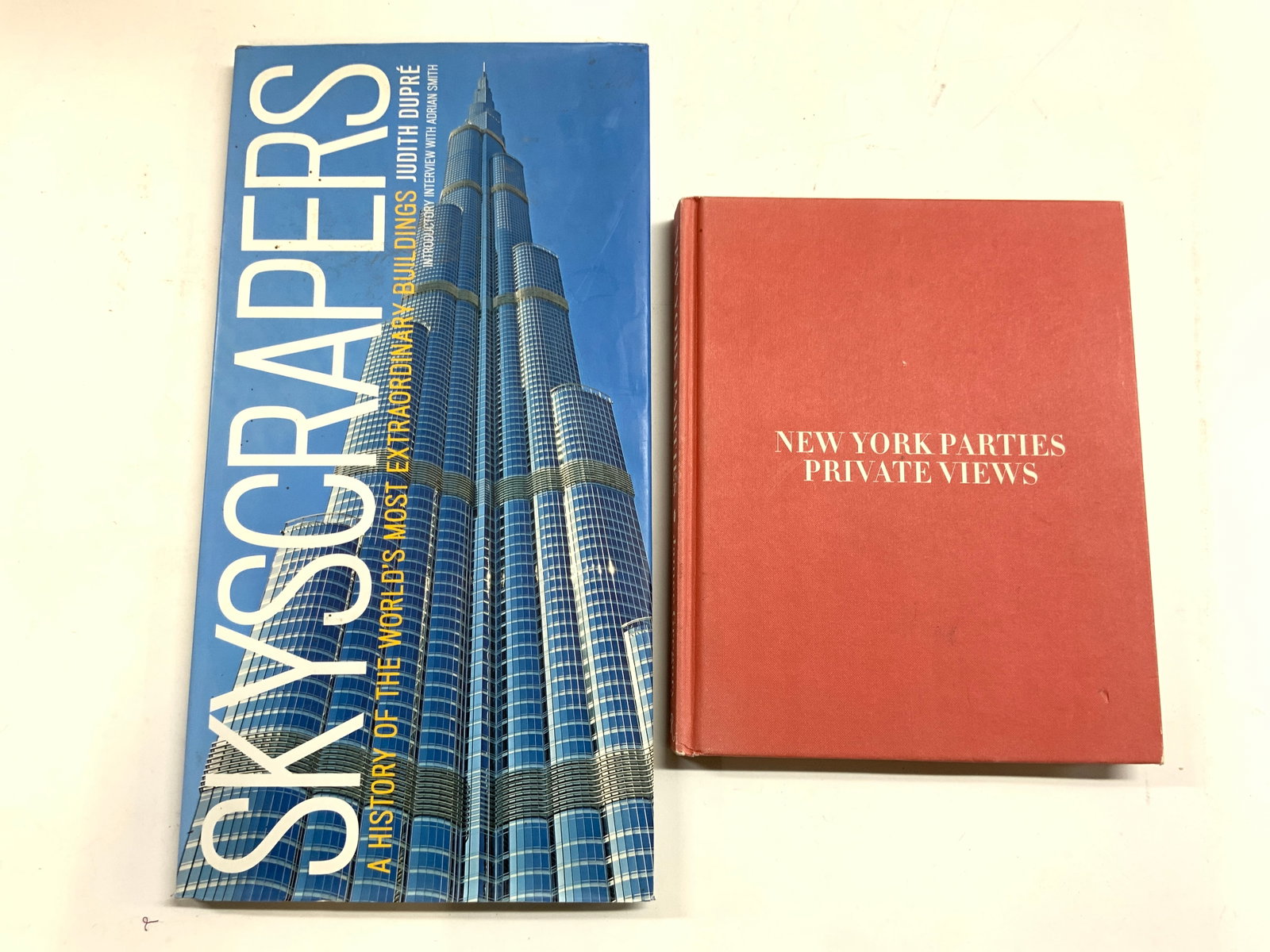 2 Books NY Private Parties 2010 Skyscrapers 2013: Lot includes NEW YORK PRIVATE PARTIES BY JAMEE GREGORY (Publ 2010) & SKY SCRAPERS A HISTORY OF THE WORLDS MOST EXTRAORDINARY BUILDINGS BY JUDITH DUPRE (publ 2013). Each book is hardcover. Largest book
