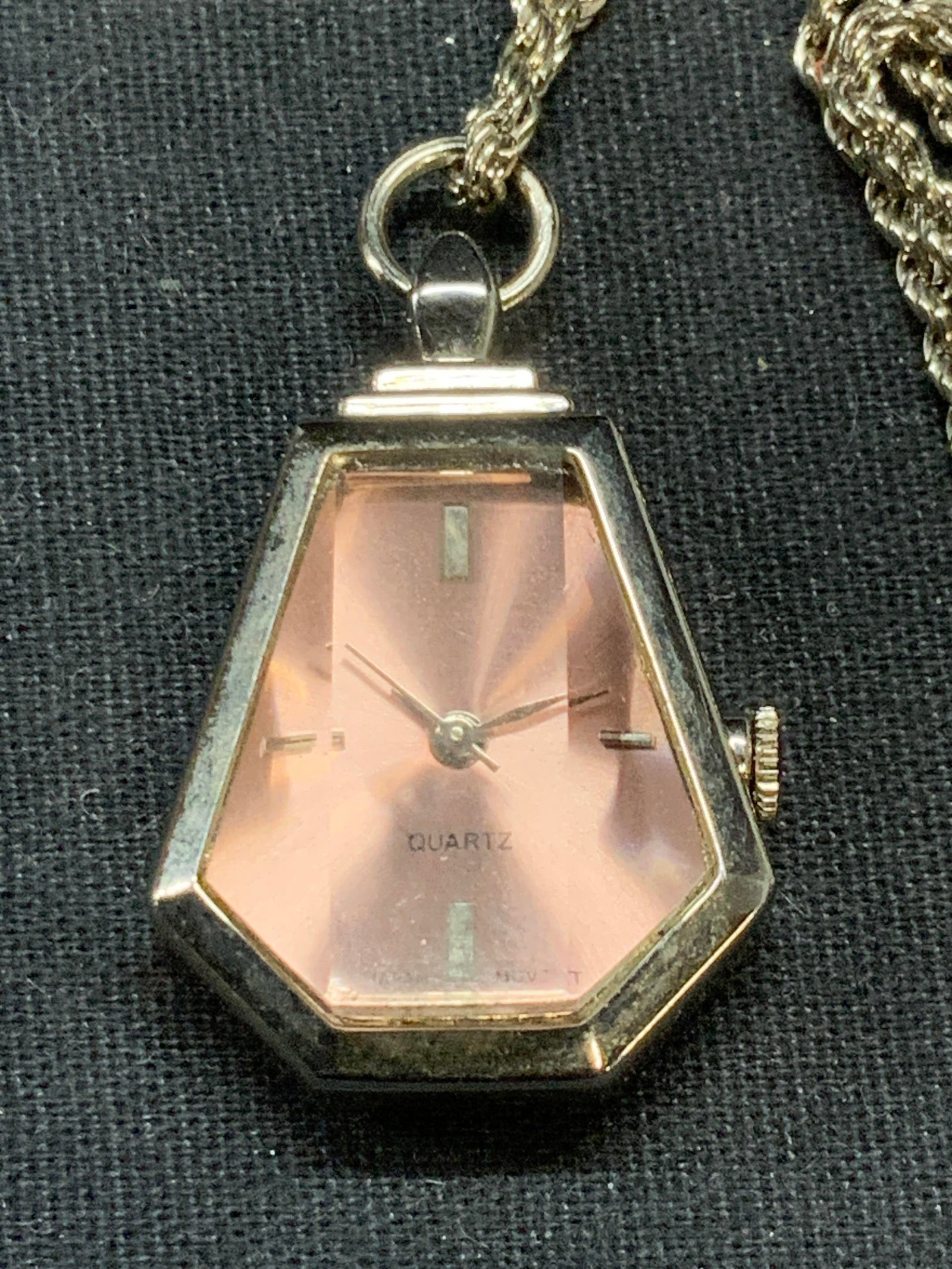 Silver Tone Watch Pendant Necklace: Silver tone necklace with silver tone and pink Watch pendant. Drop length approx. 13.5 inches. Pendant measures approx. 1 x 1 inches. Not tested for function. Some surface wear including scratching ob