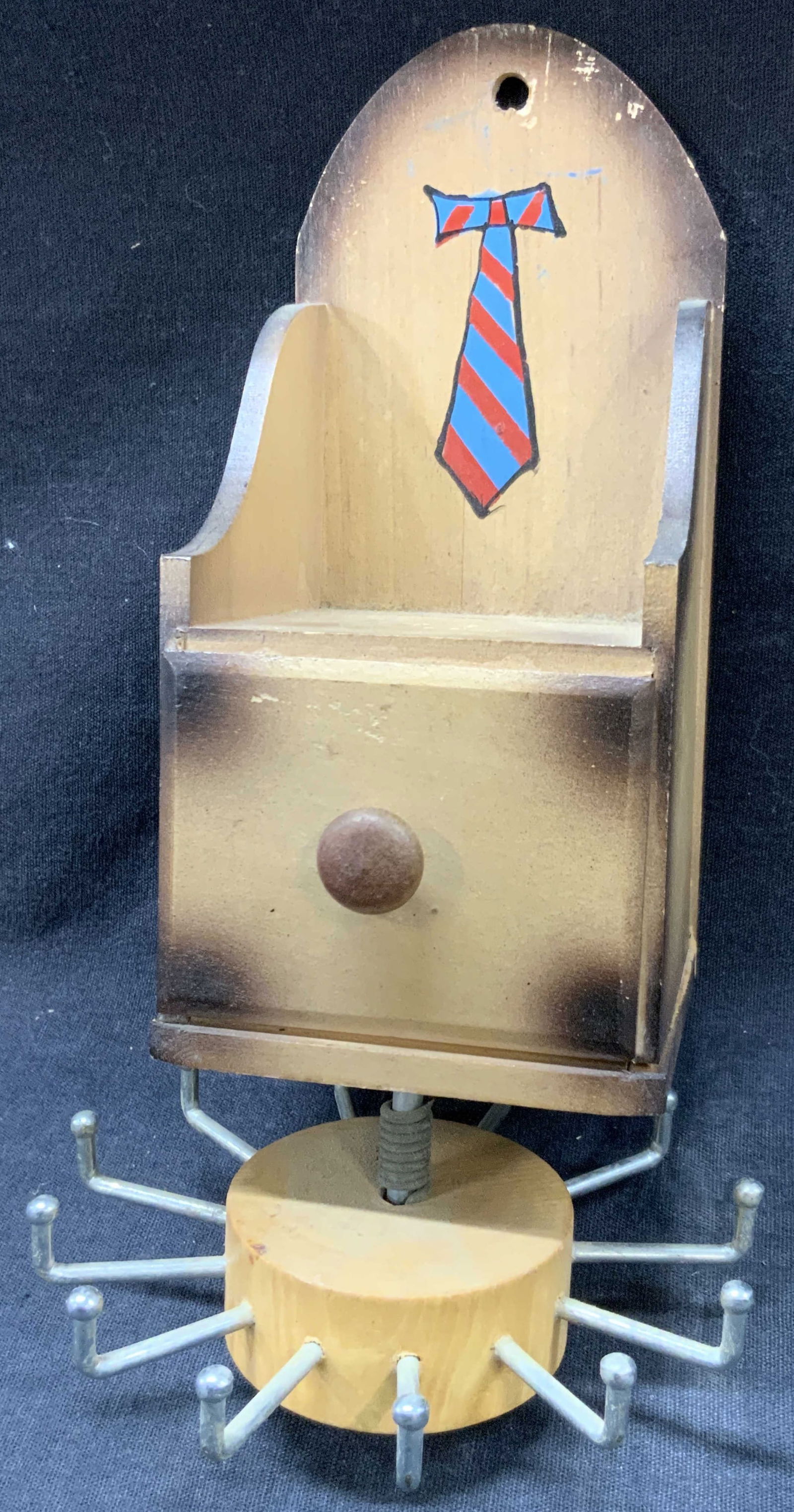 Vntg Wooden Tie & Clip Wall Hanger, Japan: Vintage wooden wall tie rack with clip drawer, button rotating rack to hang ties and a drawer to keep tie clips in. Approx 8 x 3 x 3 inches. Marked Japan on backside Moderate wearing to wood throughou