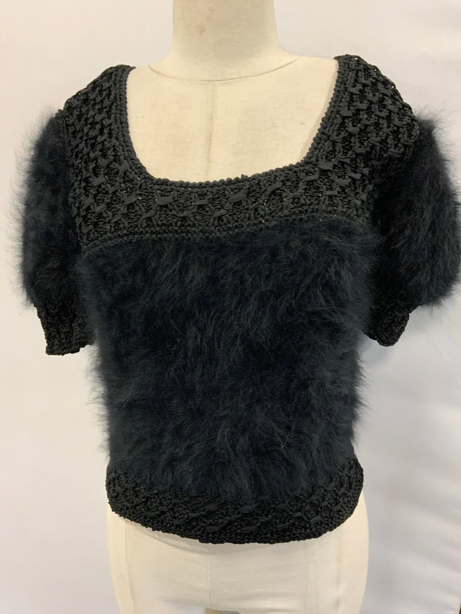 Black Fur and Crochet Short Sleeve Sweater: Black sweater that has soft hand fur ( possibly rabbit fur) and crochet design. Possibly hand made. Squared neckline. Size small or medium.,21 in long. 32 in. waist. Wear throughout. Sweater, ladies w