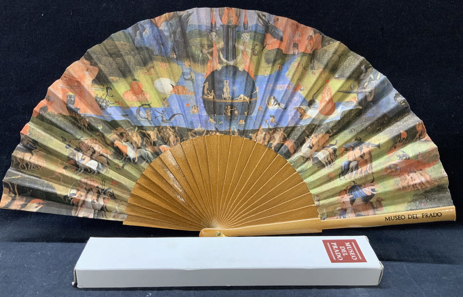Hieronymus Bosch Prada Museum Fan, Spain: Marked on fan and on original box, Museo de prado. Depicting art from Hieronymus Bosch. Approx 9 inches long and box measures 10 inches long Minor wearing to wooden fans and fabric, moderate wearing t