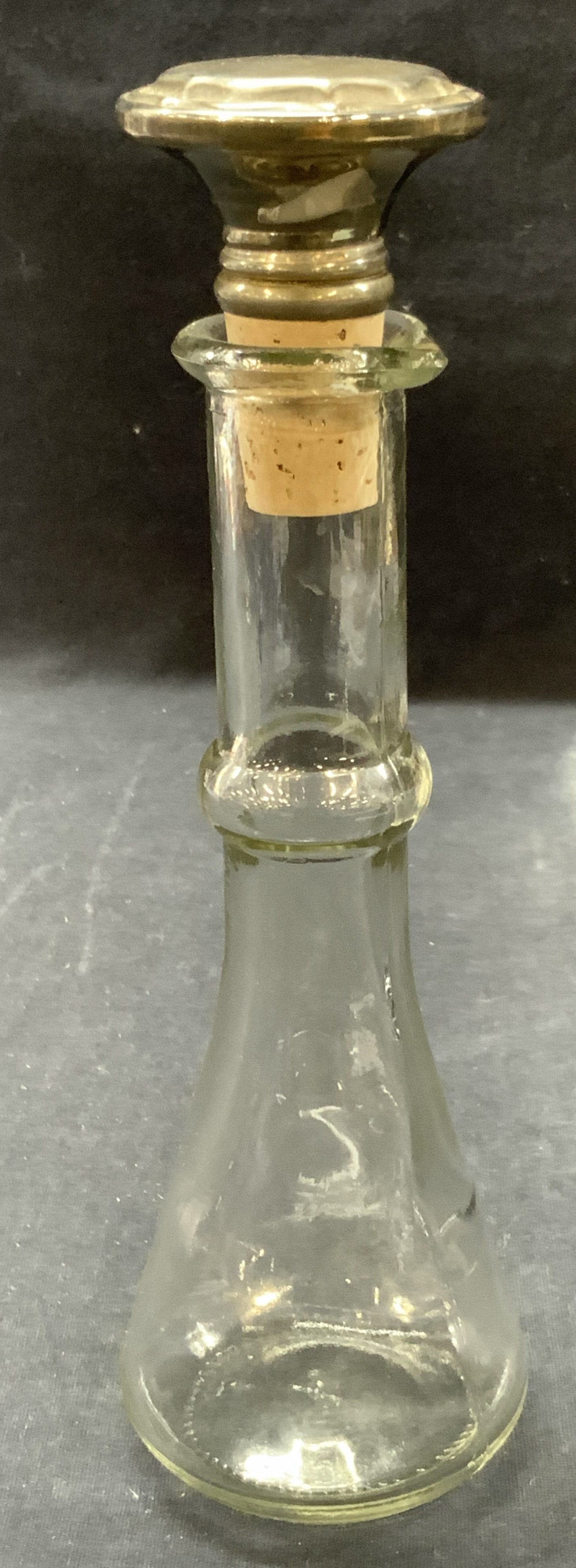 Vntg Glass Bottle W Plated Cork Stopper: Vintage glass bottle with hallmark on underside, comes with silver plated cork stopper with twist off cap that reveals a spout. Approx 9 inches tall and 2 inch wide base. Home decor, Liquor bottle, gl