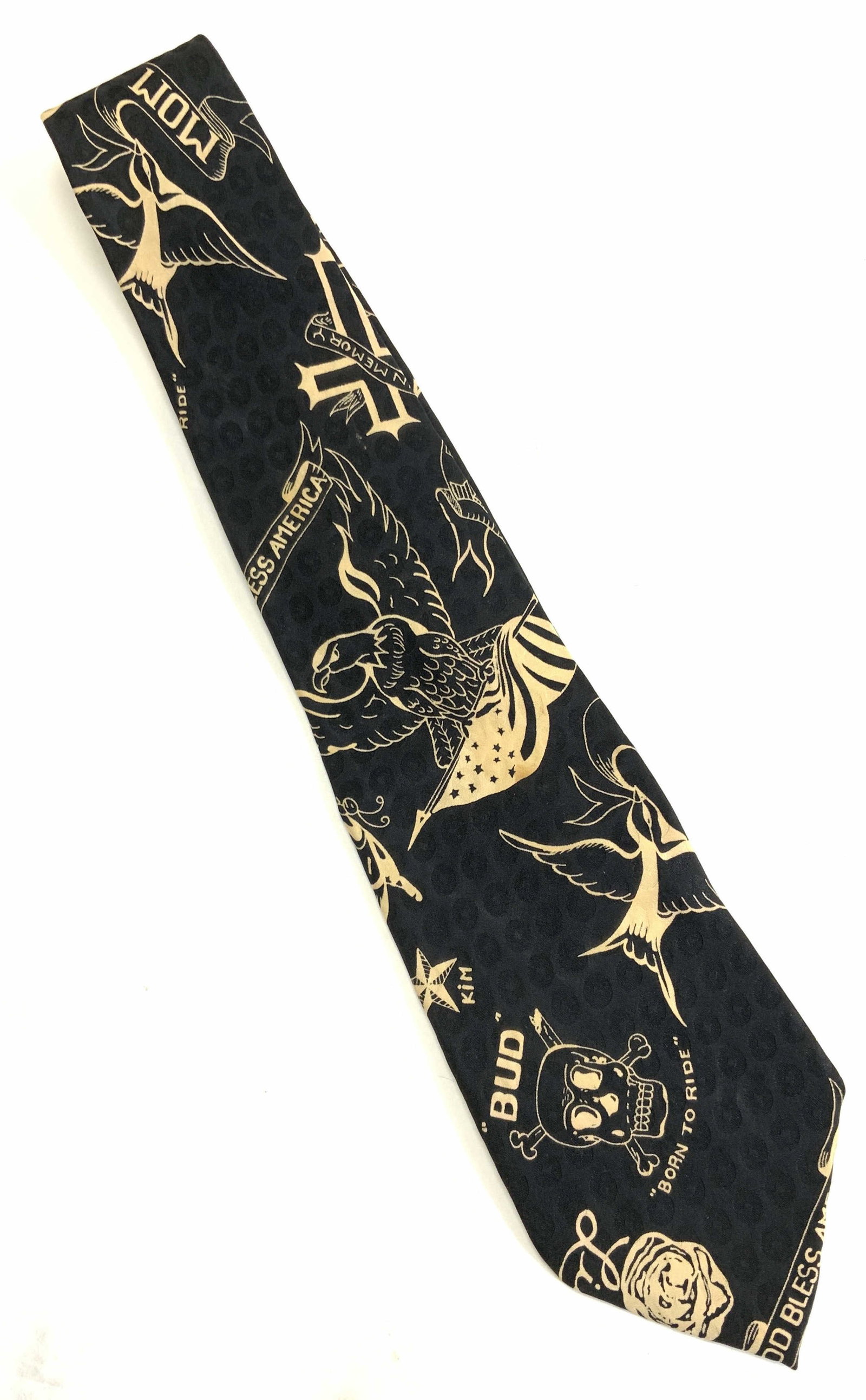Nicole Miller Silk Tie: Black silk tie by designer Nicole Miller. Gothic print with Skull and Bone, American Eagle, Byzantine Latin cross, nautical prints, etc. 3.75 in. Wide, 55.25 in. Long. Blemishing on front and back. Me