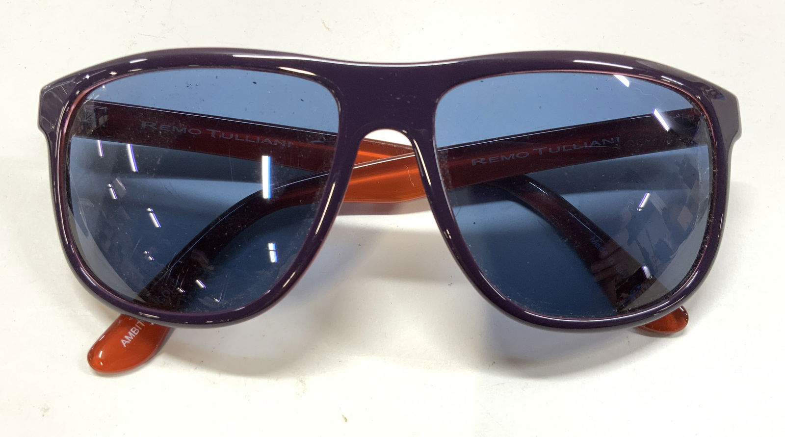 Remo TULLIANI Ambition Sunglasses, Blue Lens Italy: Hand crafted REMO TULLIANI sunglasses with blue lens, non prescription. Made in Italy. No lens scratches or surface wear noticed to glasses. 5.5 in. Length arms. Lens length 5.75 in., ht 2 1/8 in. Mad