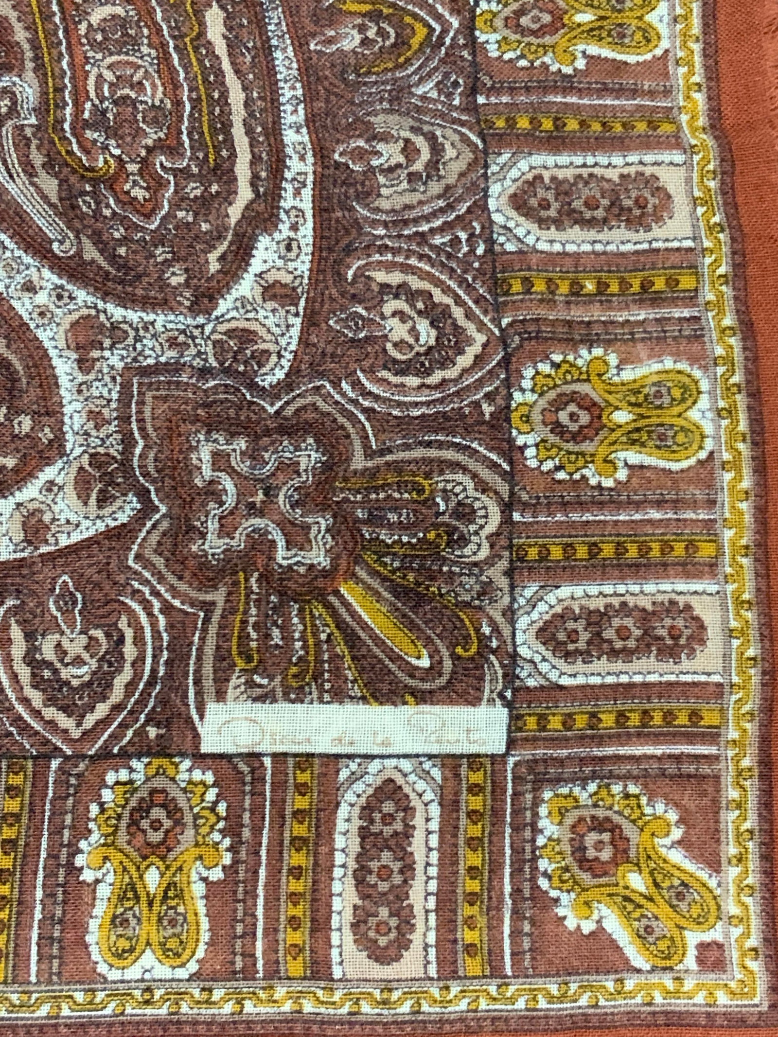 Oscar De La Renta cashmere Paisley Scarf: Marked on scarf, Oscar de la rental, earth tone, possibly silk or cotton scarf with paisley designs with slight fringe ends. Approx 30 x 30 inches Minor wearing to scarf. Oscar de la Renta scarf, cash