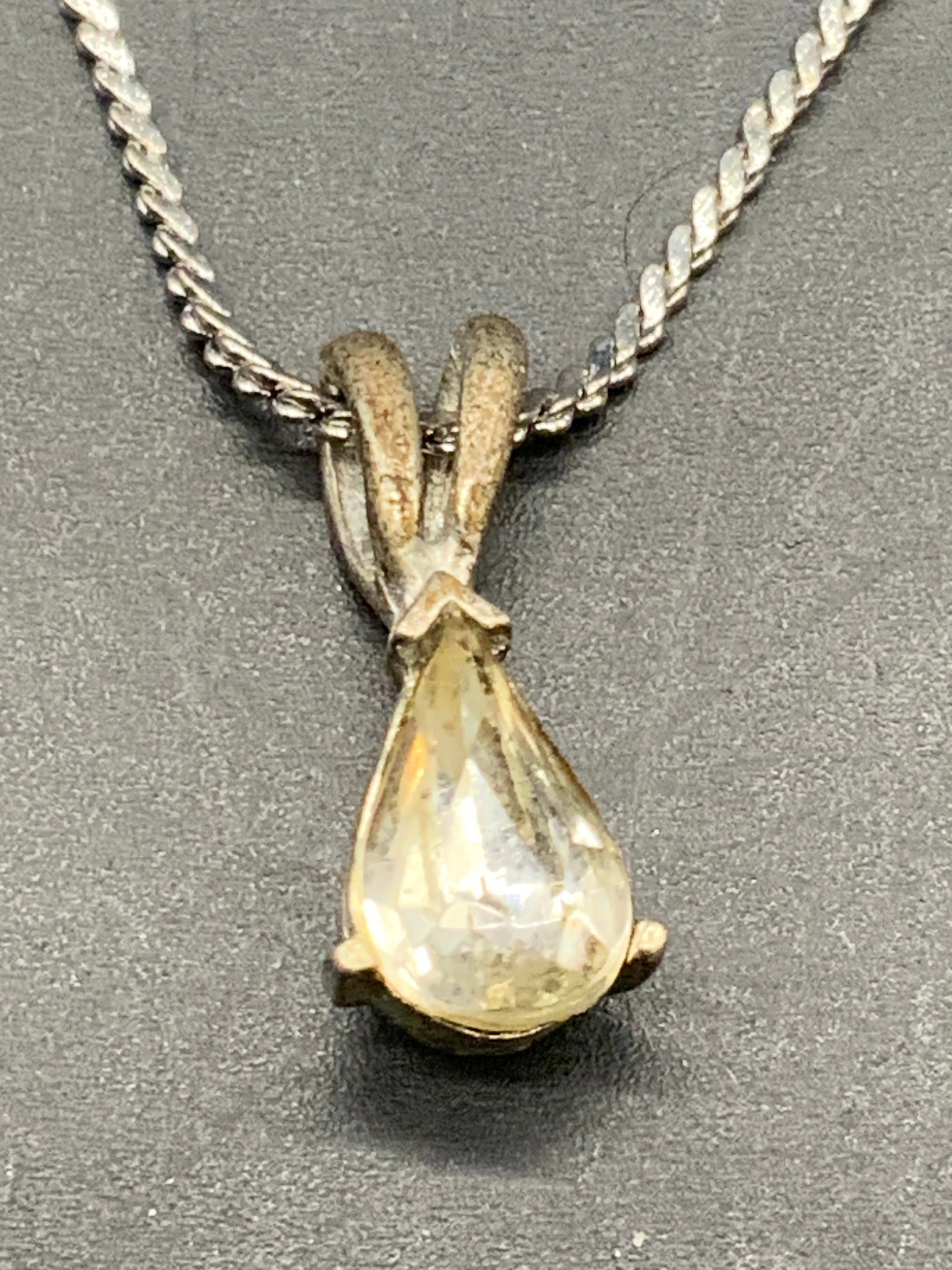 Vintage Crystal Pendant Necklace, Jewelry: A vintage silver tone metal choker necklace featuring a silver tone metal teardrop form pendant fitted with a faceted crystal. Necklace Measures approx. 15 inches in length, measured from end to end. 