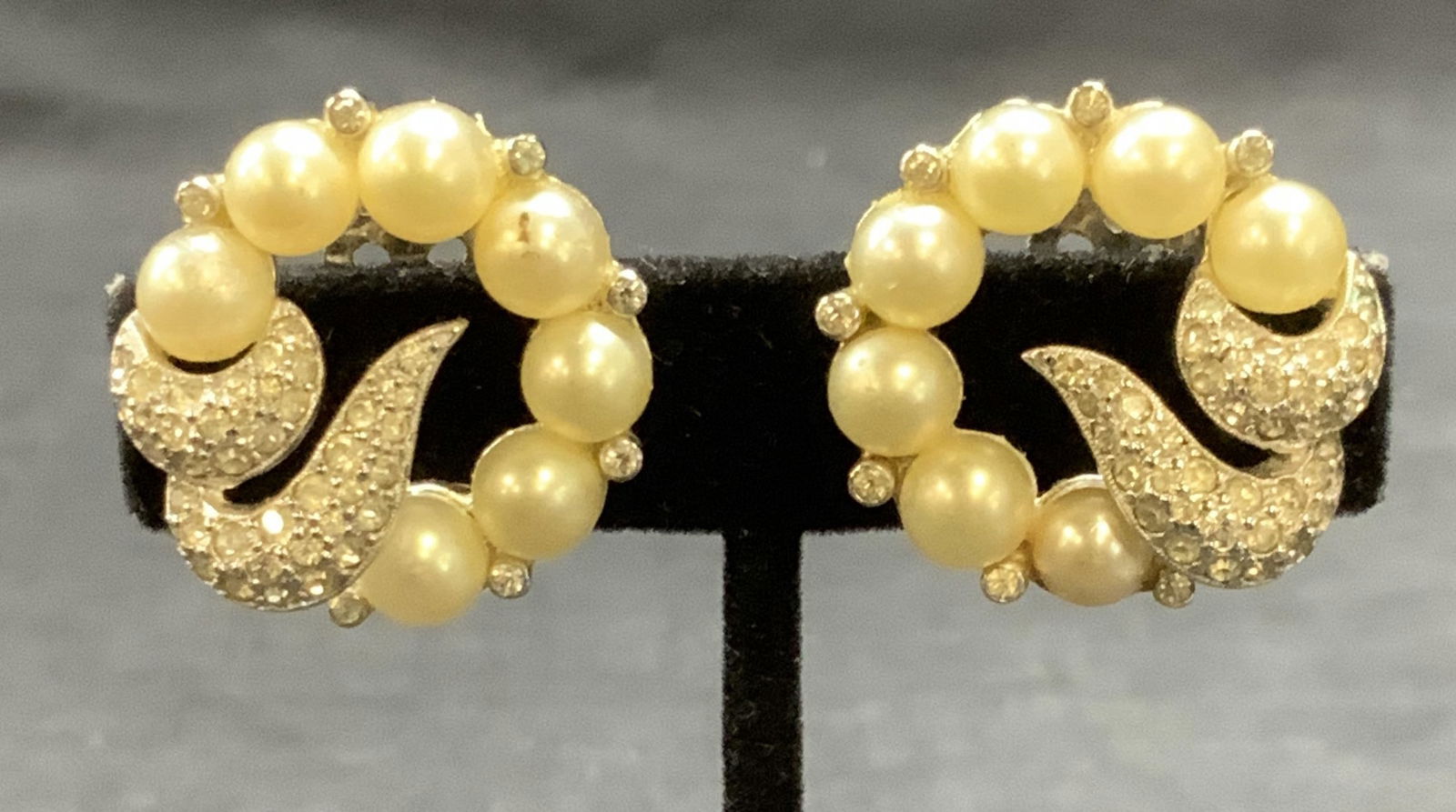 Vntg Jomaz Silver Tn Faux Pearl Crystal Earrings: Vintage Jomaz silver tone faux Pearl and colorless crystal earrings. Clip on backing. Signed to backing. Measure approx. 1 inch wide. Some surface wear including scratching observed. Estate jewelry, c