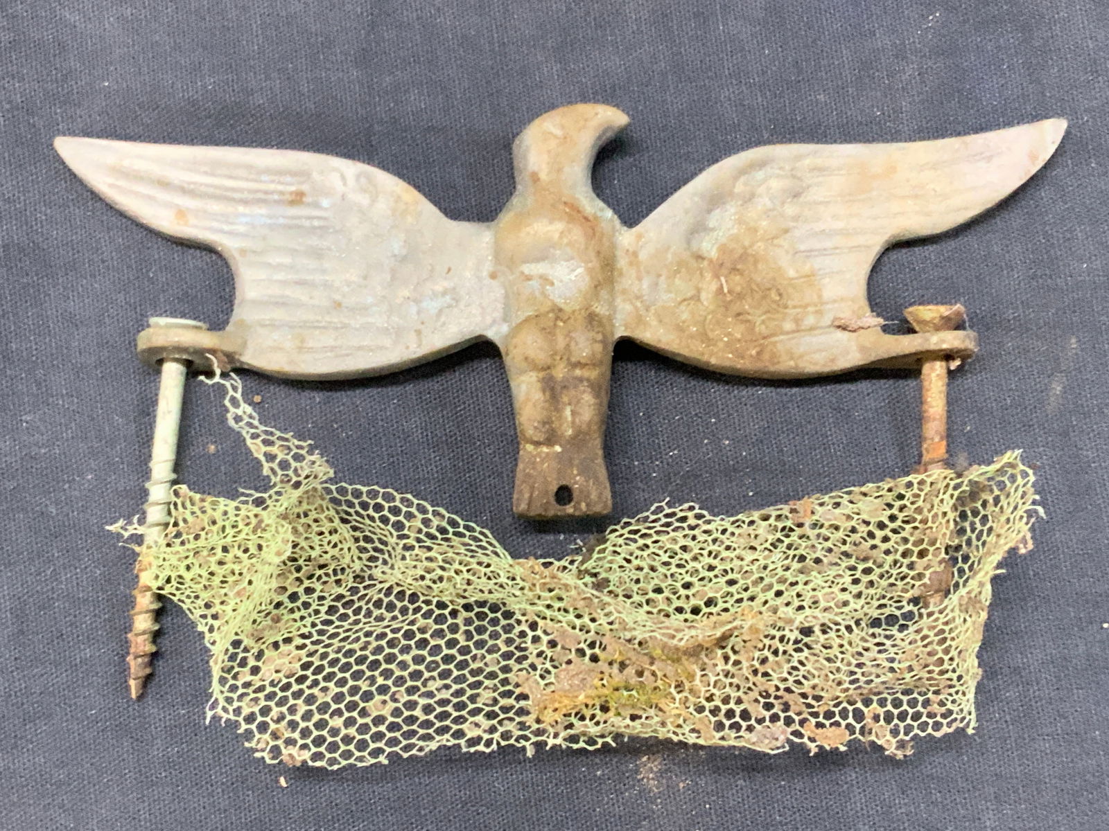 Vntg Etched Metal Eagle Ornament: Vintage ornament of an eagle, possibly made of white metal or pewter etch etchings on wings. Comes with screws for hanging. Approx 2 x 5.25 inches Moderate discoloration and wearing due to age and use