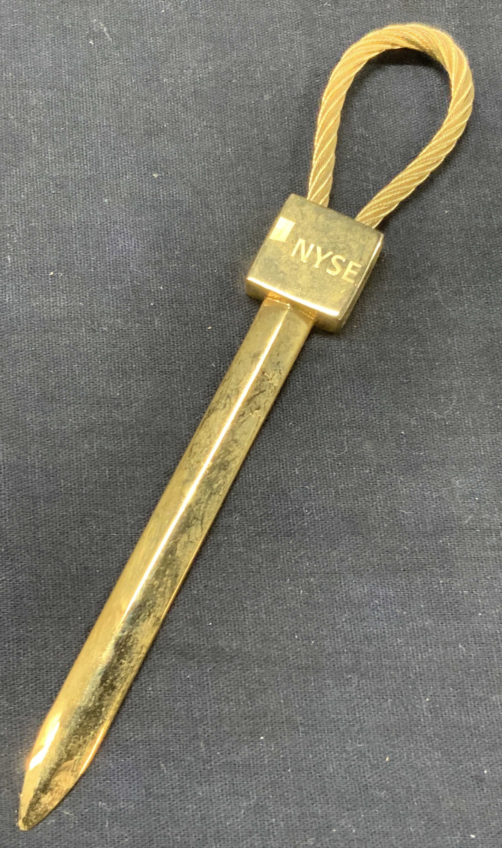 Vntg New York Stock Exchange Brass Letter Opener: Vintage brass made letter opener with braided rope on end, marked NYSE, New York stock exchange, approx 6 inches long. Moderate surface wearing to brass due to age and use Vintage brass decor, brass l