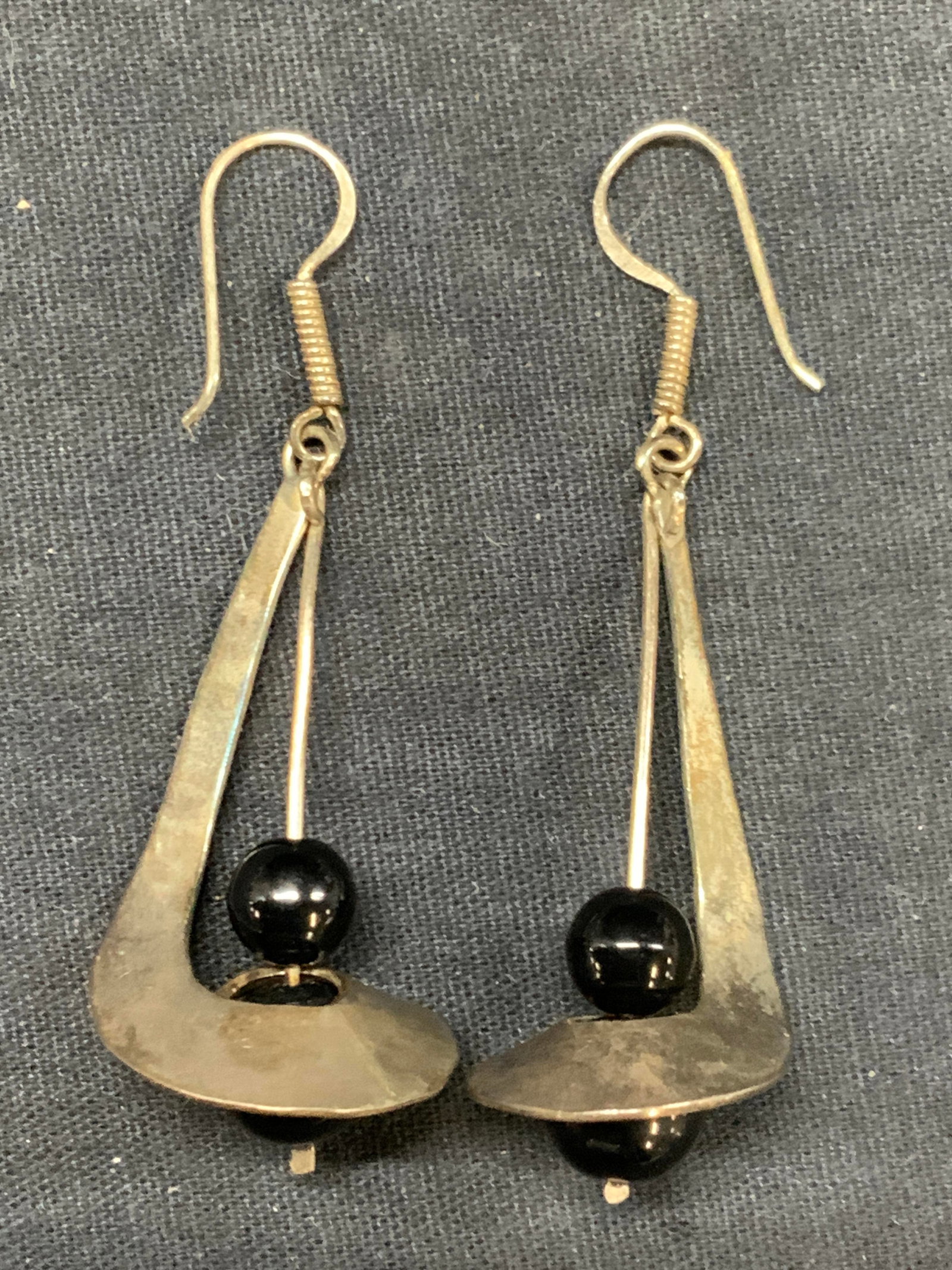 Pr Sterling Silver Sculptural Earrings, Mexico: Pair of earrings, marked Mexico 925, made in a spiral figure with black glass or stone bead in the center. Approx 2.5 inches long Moderate wearing to sterling due to age and use. Total weight of sterl