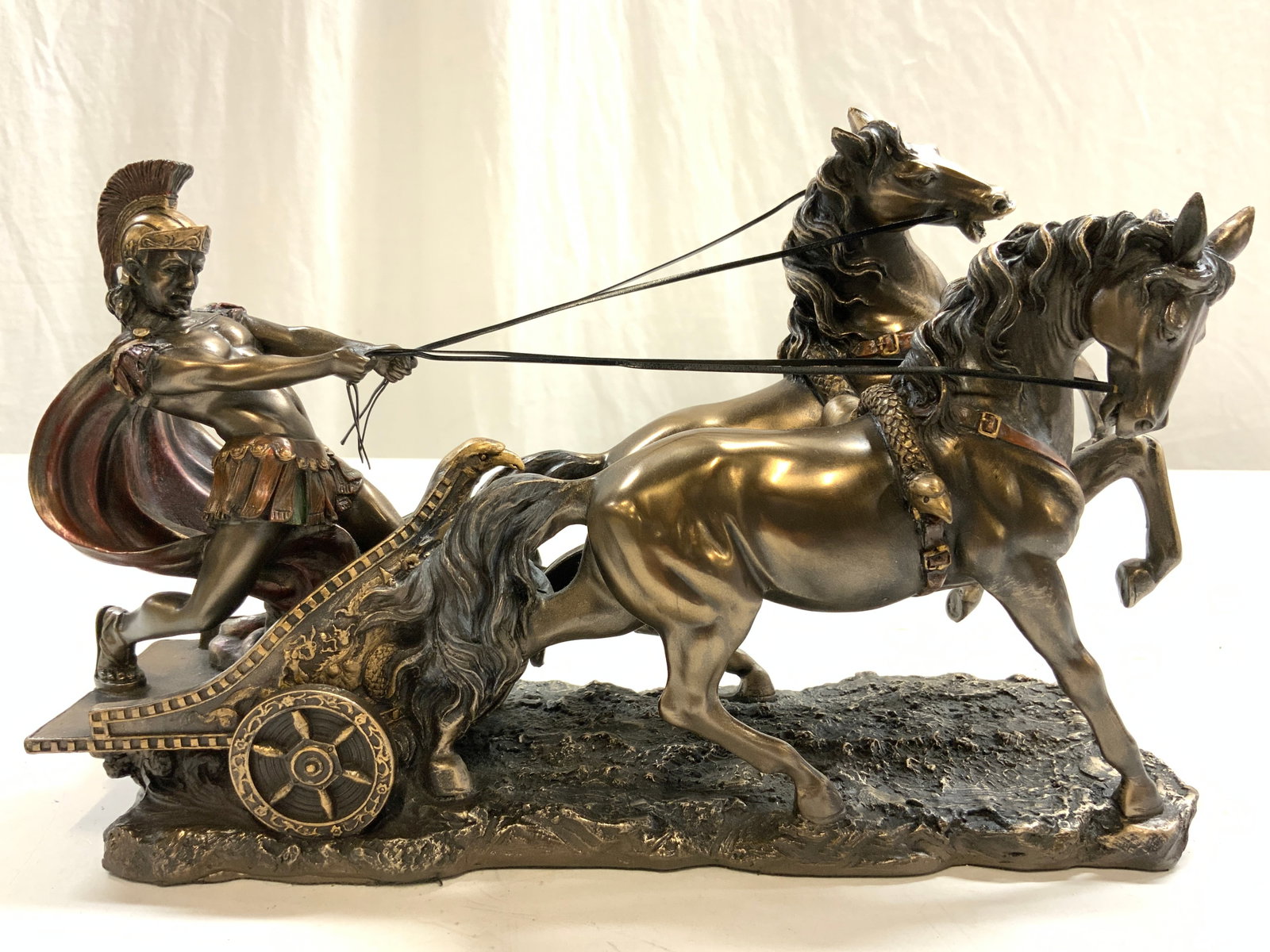 VERONESE DESIGNS Gilt Wood Roman Chariot Fig: Underside reads VERONESE DESIGNS. Figure depicts a Roman Chariot. Soldier & chariot being pulled by 2 galloping horses. Piece appears to be gilt wood, possibly composite, possibly resin. Piece has int