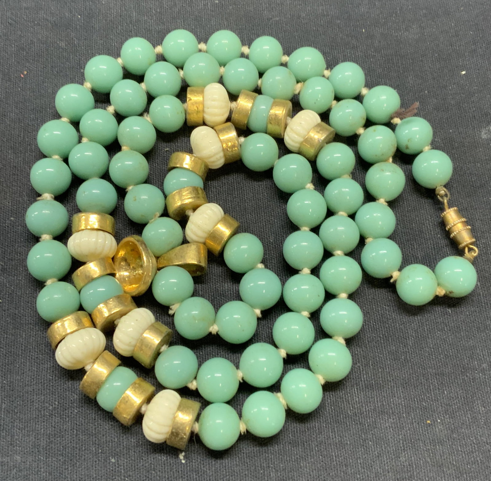 Vintage Turquoise Style Gold Tn Beaded Necklace: Vintage turquoise style beaded necklace with embossed white and gilt tone accent beads. Drop length approx. 16 inches. Necklace has weight. Some scratching observed. Estate jewelry, costume jewelry, c