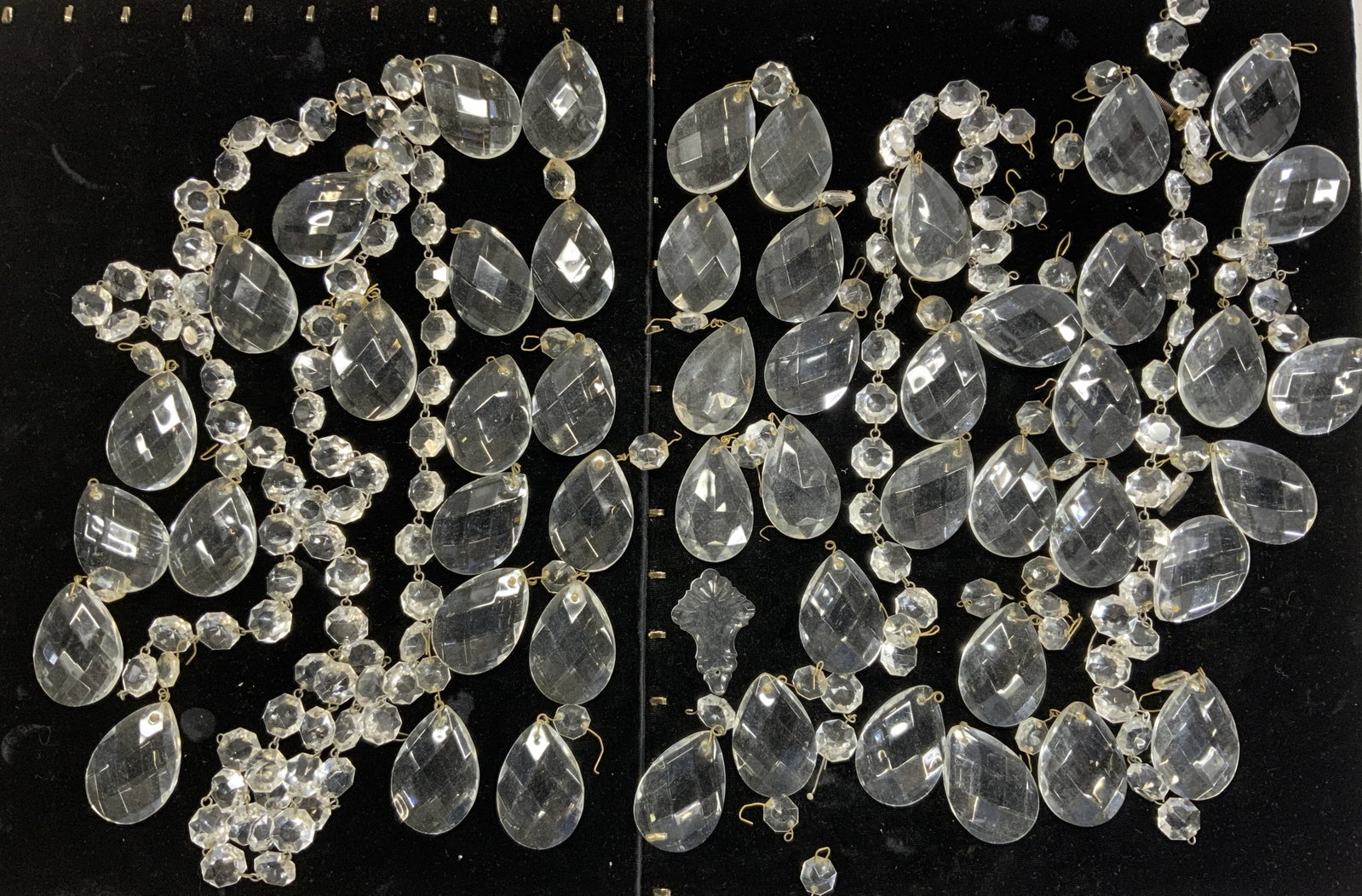 Large Lot of Chandelier Faceted Prisms, 45+: Faceted clear resin prisms in tear drop shape and octagonal chain chain link prisms. Tear drop prisms measure 2 x 1.25 in. Over 45 individual items, at least 42 tear drop prisms. Chandelier prisms, de