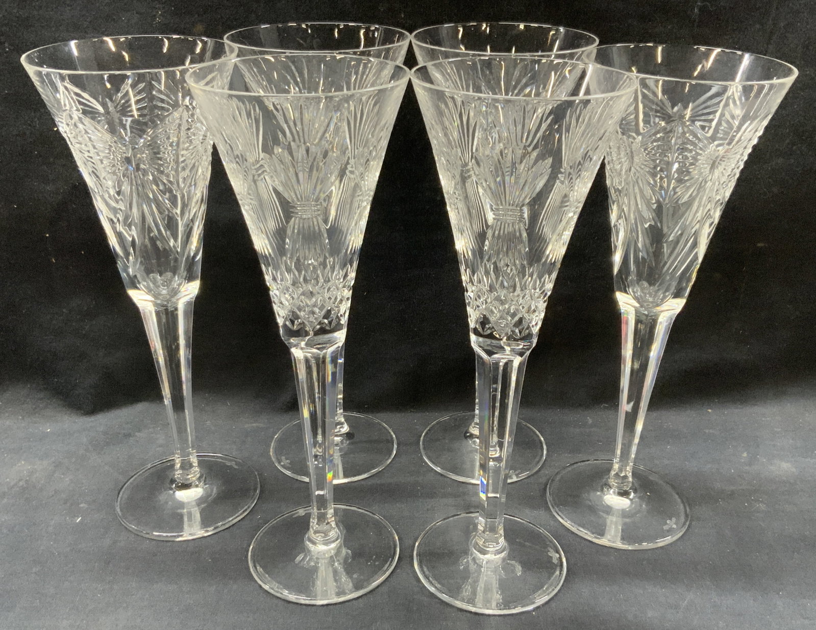 Set 6 Waterford Cut Crystal Stemware: Set of 6 cut crystal stemware glasses with 2 having matching etchings of bungles of hay, 2 with ribbon designs and 2 with Star burst designs. Marked Waterford on undersides. Approx 9 inches tall and 3