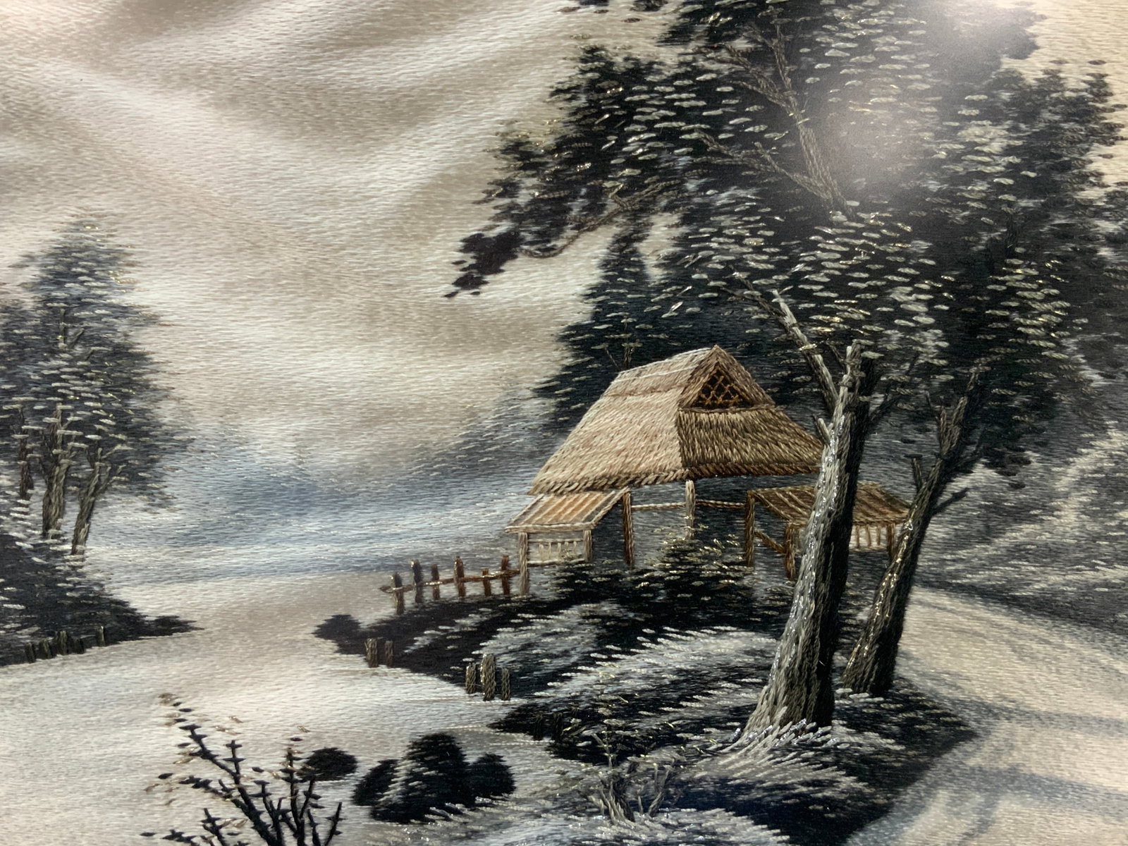 Asian Snowy Landscape Silk Embroidery Panel: Snowy landscape of a Japanese strew roof house made of silk embroidering. Framed in gold leafed wooden frame with off white matting. Approx 15 x 20 inches window measures 9.5 x 14 inches Moderate wear