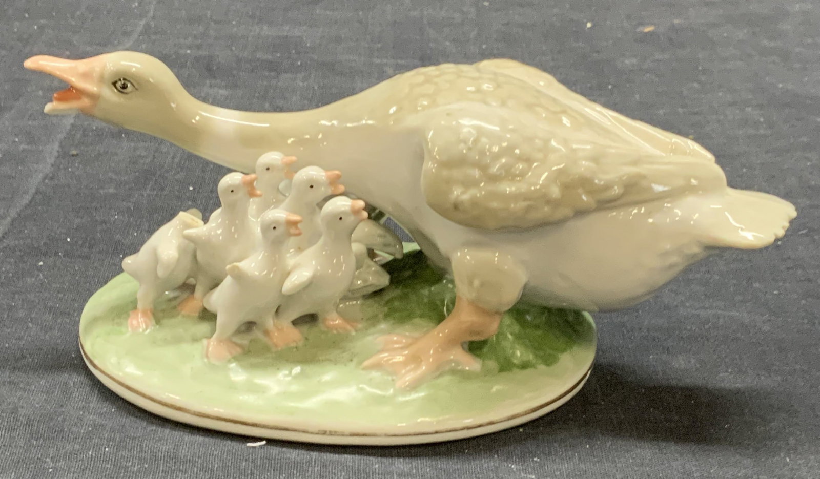 AYAEBO Porcelain Goose Figurine, Russia: AYAEBO porcelain goose figurine. Trademarked to underside. Made in Russia. Some surface wear consistent with exposure. Measures approx. 6.75 x 3.5 x 2.75 inches. AYAEBO, AYAEBO figurine, porcelain fig