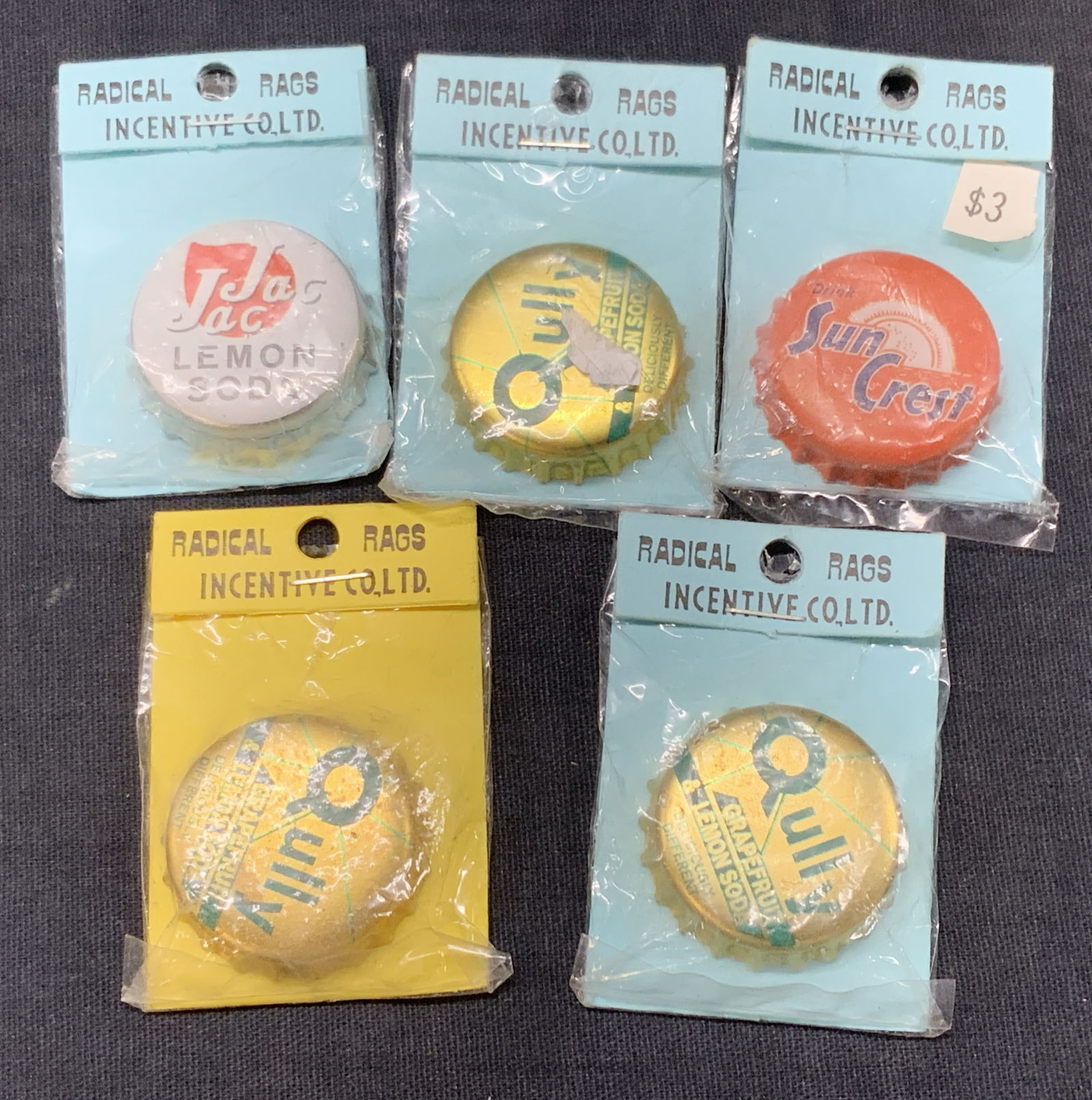 Lot 5 Vntg Bottle Cap Magnets, NIP: Lot of 5 bottle cap magnets, new in packaging marked Incentive Cl. Ltd. 3 out of 5 caps read Qully, grape fruit & lemon soda, 1 reads Jac Jac And the other reads Sun crest. Approx 2 x 1.75 inches Mino