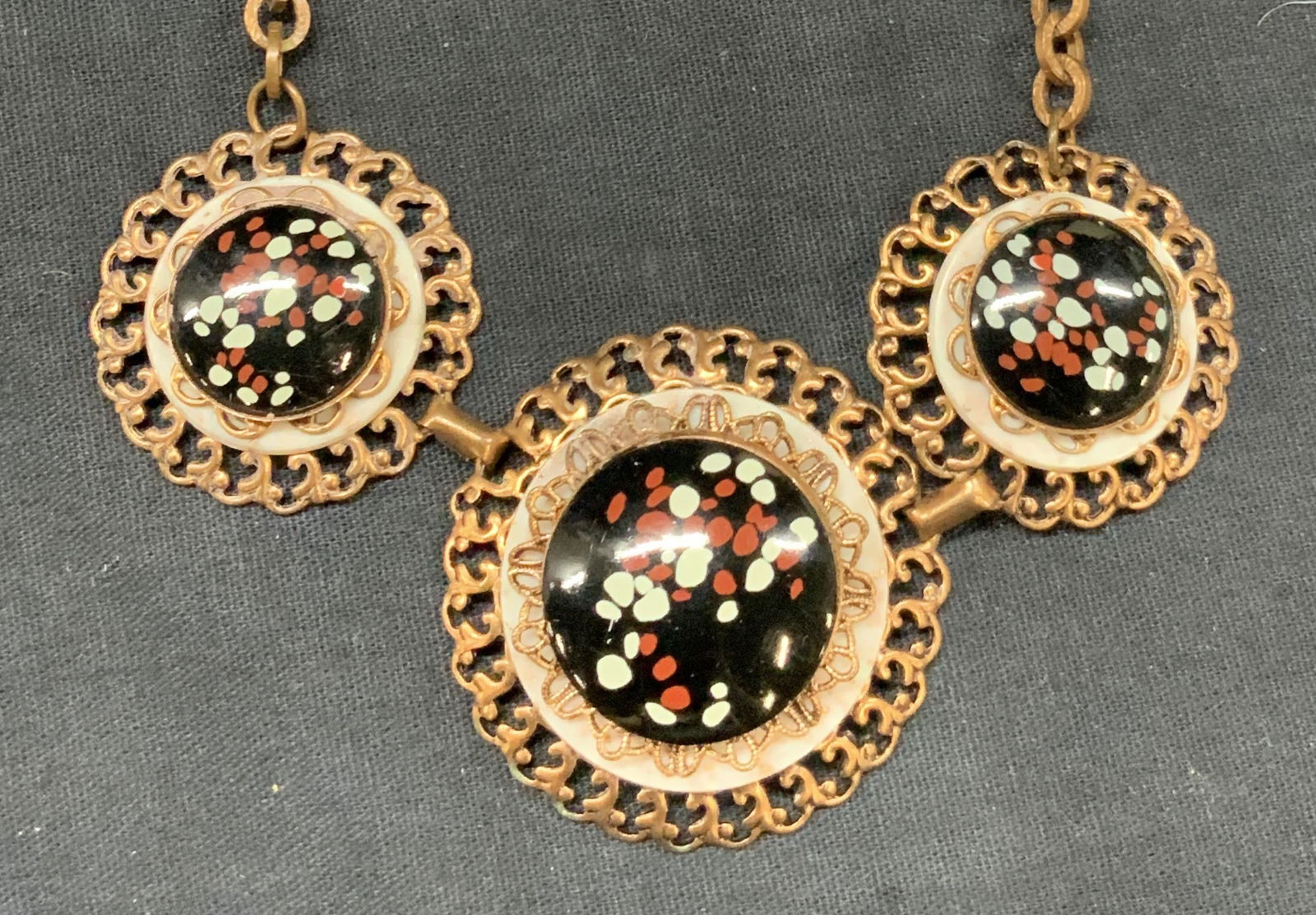 Created Copper & Enamel Choker Necklace: Choker necklace made of copper chain and pendants with black speckled with red and white. Approx 6 inch drop and 15 inches across. Moderate wearing to copper due to age and use. Copper necklace, coppe