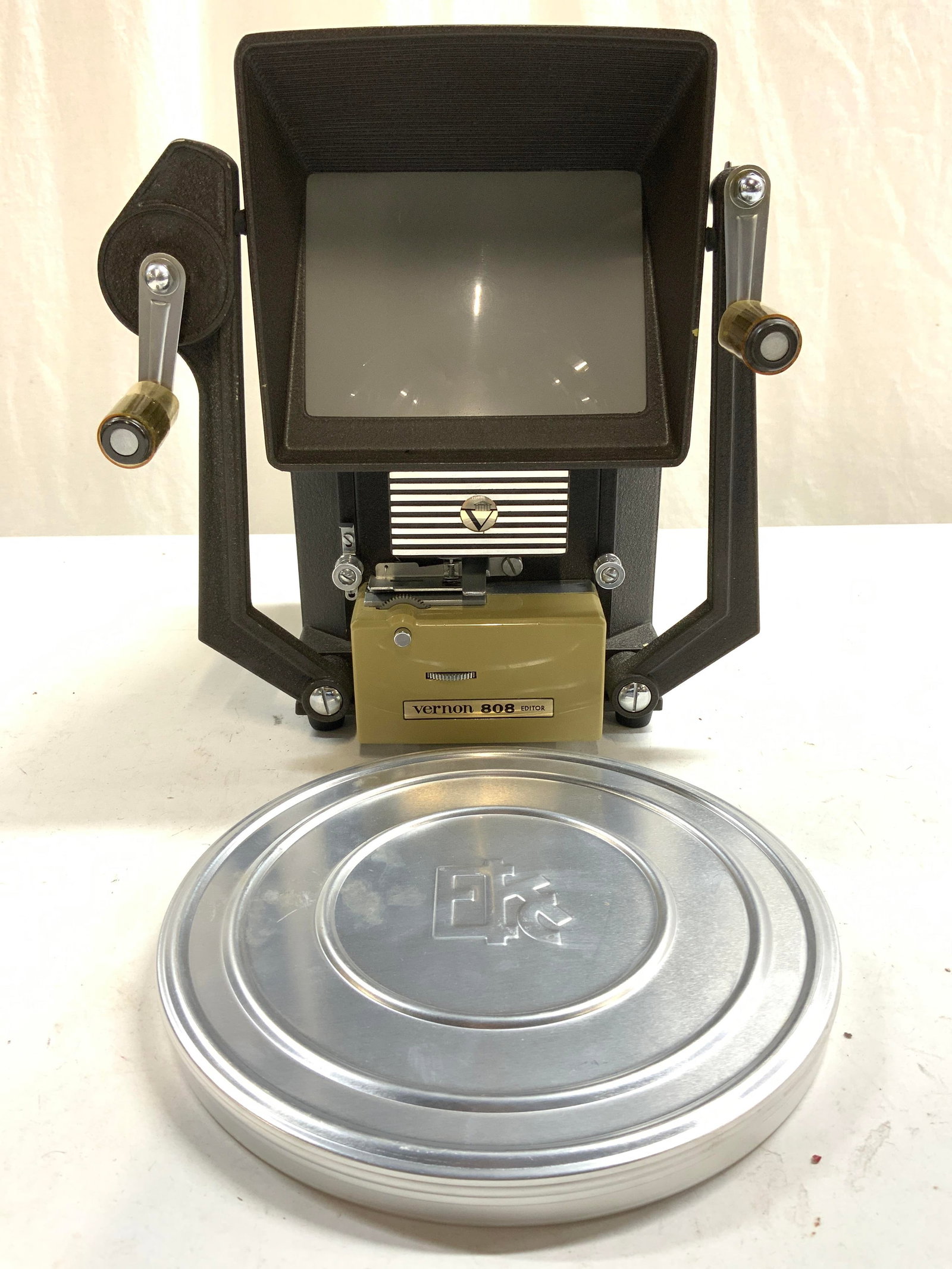 VERNON 808 EDITOR W Box: Vernon 808 Editor. Piece has cranks on sides. Includes silver toned metal film canister. Editor measures approximately 9.5 inches tall 8.5 inches wide 8 inches deep. Editor, Vernon editor, Vernon 808 