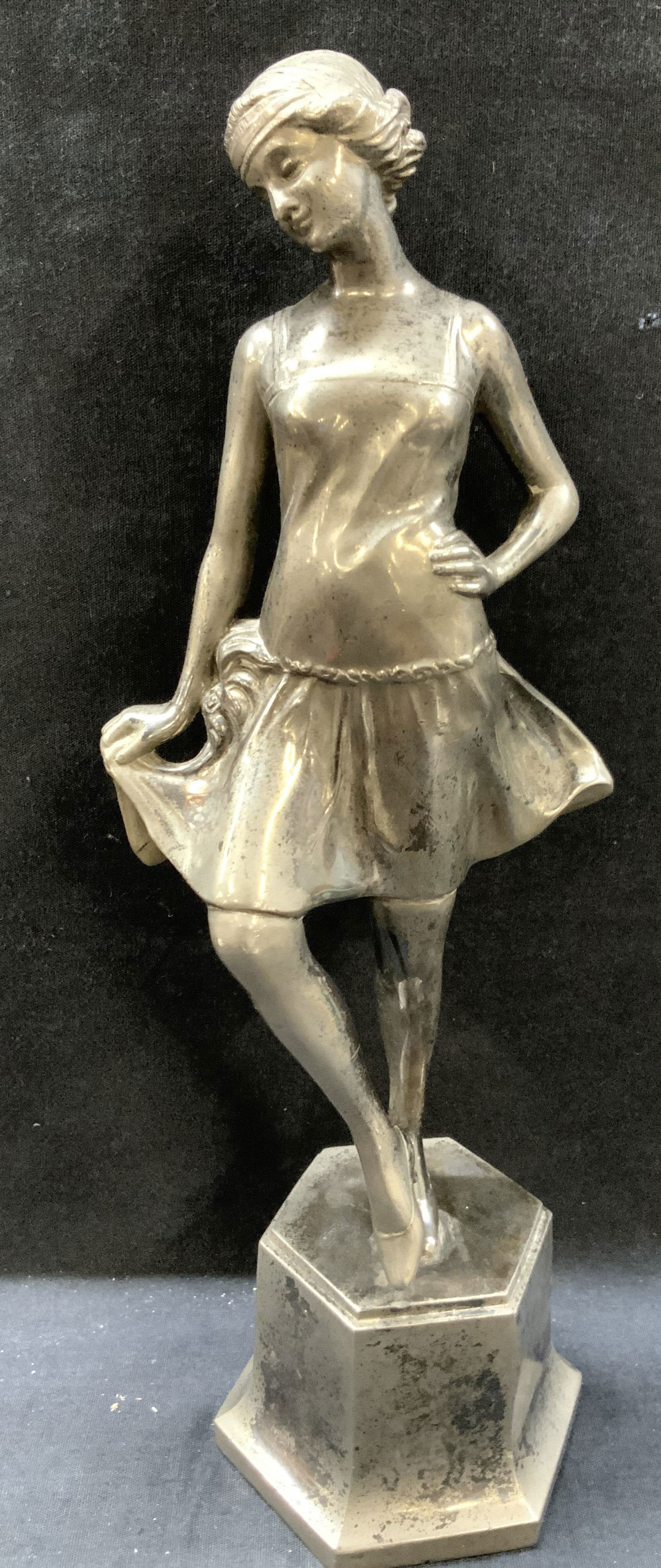 Cast Silver Gilt Pewter Flapper Figural: Cast pewter figure of a flapper girl with short hair, tight dress and robe wisest belt with feathers. Approx 14 inches tall and 5 inches wide and 4 inch diameter base. Moderate surface wearing to mate
