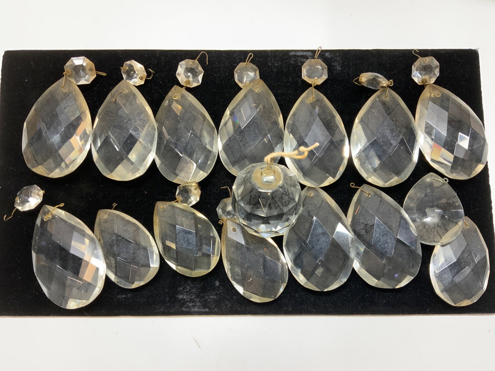 24 Facted Chandelier Prisms, Ball Prism: Heavy tear drop prisms with octagonal prisms. 24 total. All prisms are resin , larger size tear drop measures 3 x 2 in. Thickness 3/4 in. 10 total large size. Center faceted ball prism 1.75 x 2 in. Al