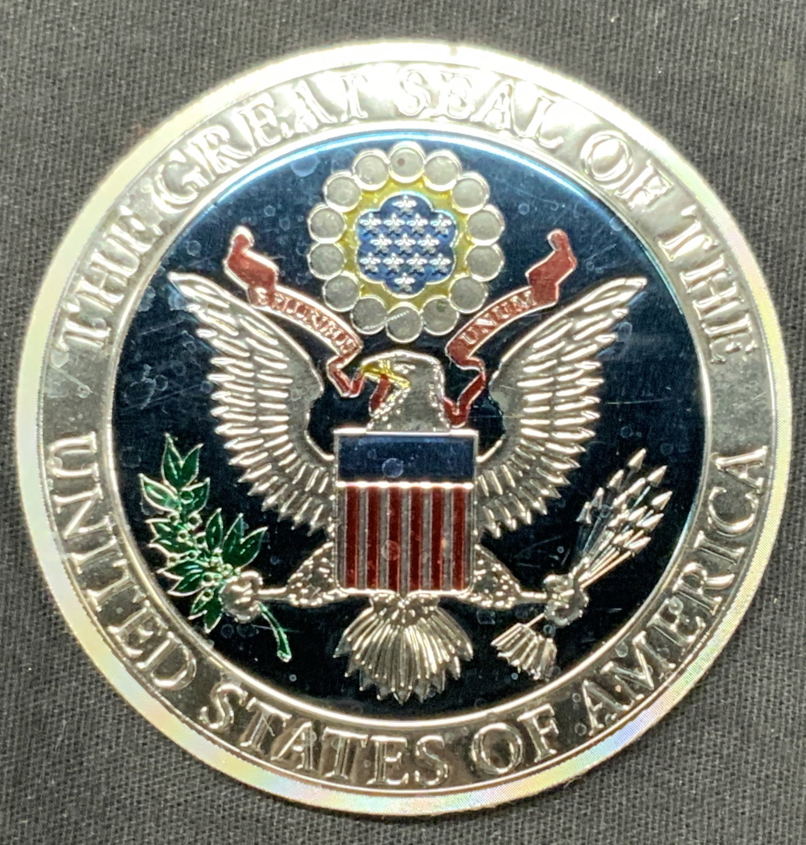 U.S.A. Seal Magnet: A magnet with the seal of the United States. Depicting the eagle seal with the words, the great seal of the untied states of America . Approx 3 inch diameter. Moderate wearing to magnet. Seal magnet, 