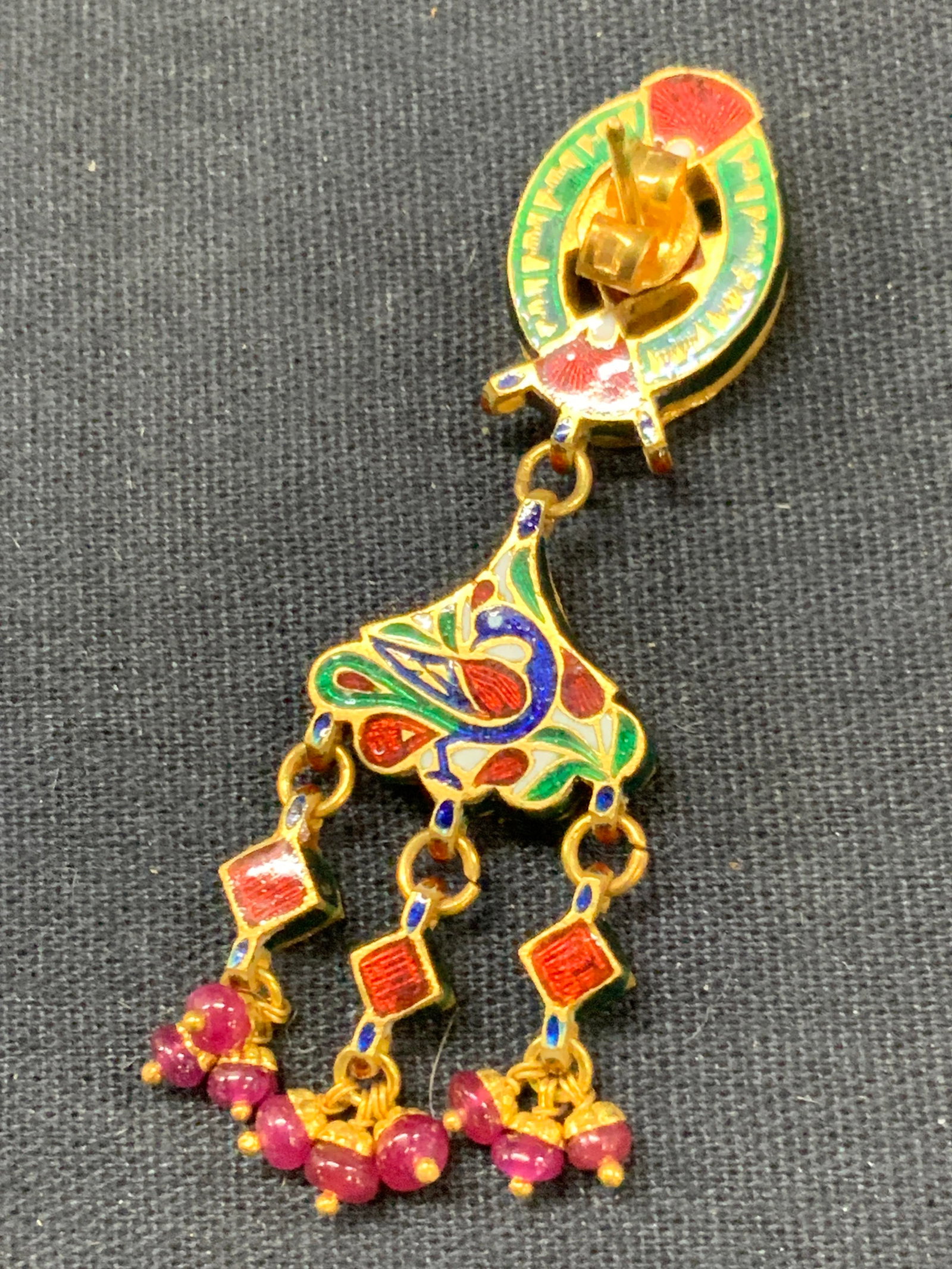 22k Gold & Diamond Enamel Earring: Marked on backside 22k, adorn with vibrant colored enamel on backside depicting the image of a peacock with the front side adorn with clear cut crystal and diamond with dangling stones of a magenta co