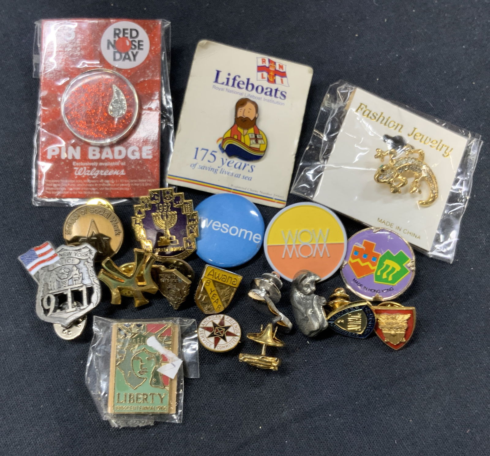 Lot 19 Vntg Pop Culture Enamel Lapel Pins: Lot of 19 accessories. Red Nose Day pin, life boats Figural pin, fashion jewelry lizard pin in gold toned metal. 1 Judaica pin in golf and enamel marked 1992, another pin with Dreidels. 1 pewter cat p