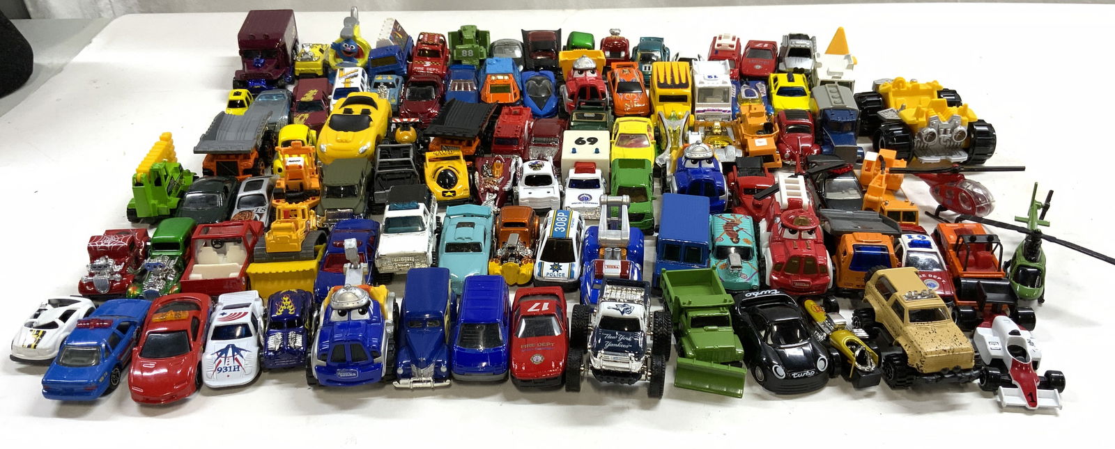 Lot 50+ Die Cast Toy Cars: Lot includes 50+ die cast toy cars. Includes brands such as hotwheels, matchbox & more. Largest piece measures approximately 4 inches deep 3 inches wide 2 inches tall. Die cast cars, toy cars, matchbo
