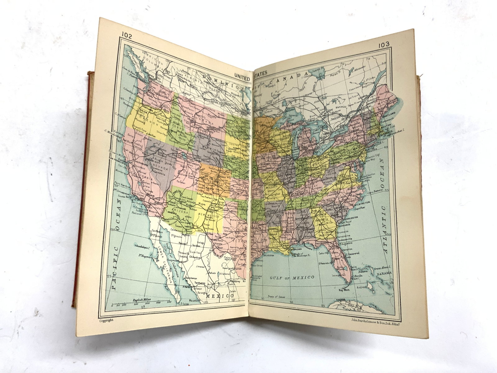 Bartholomews Pocket Atlas Of The World & Gaz GB: Cover reads BARTHOLOMEW’S POCKET ATLAS OF THE WORLD & GAZETTEER. Marked on interior printed in Great Britain by JOHN BARTHOLOMEW & SON LDT Edinburgh. Book is vintage possibly antique. Piece has red 