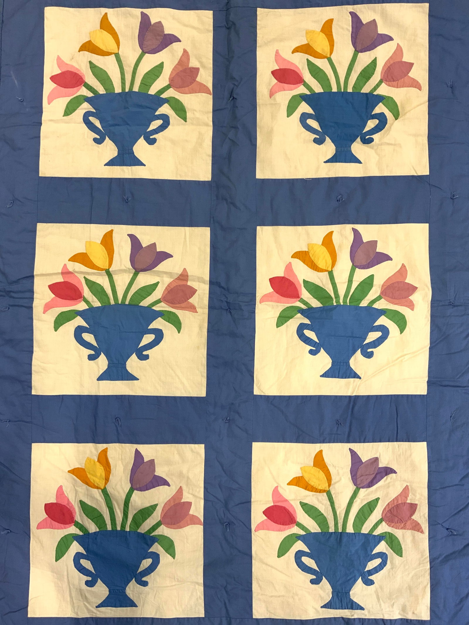 Vintage Quilt W Floral Detail: Quilt is vintage. Piece is light blue toned with cream toned squares & multi toned floral and leaf in vase detail. Measures approx 57 inches long 40 inches wide. Vintage quilt, quilt, bed quilt, flora
