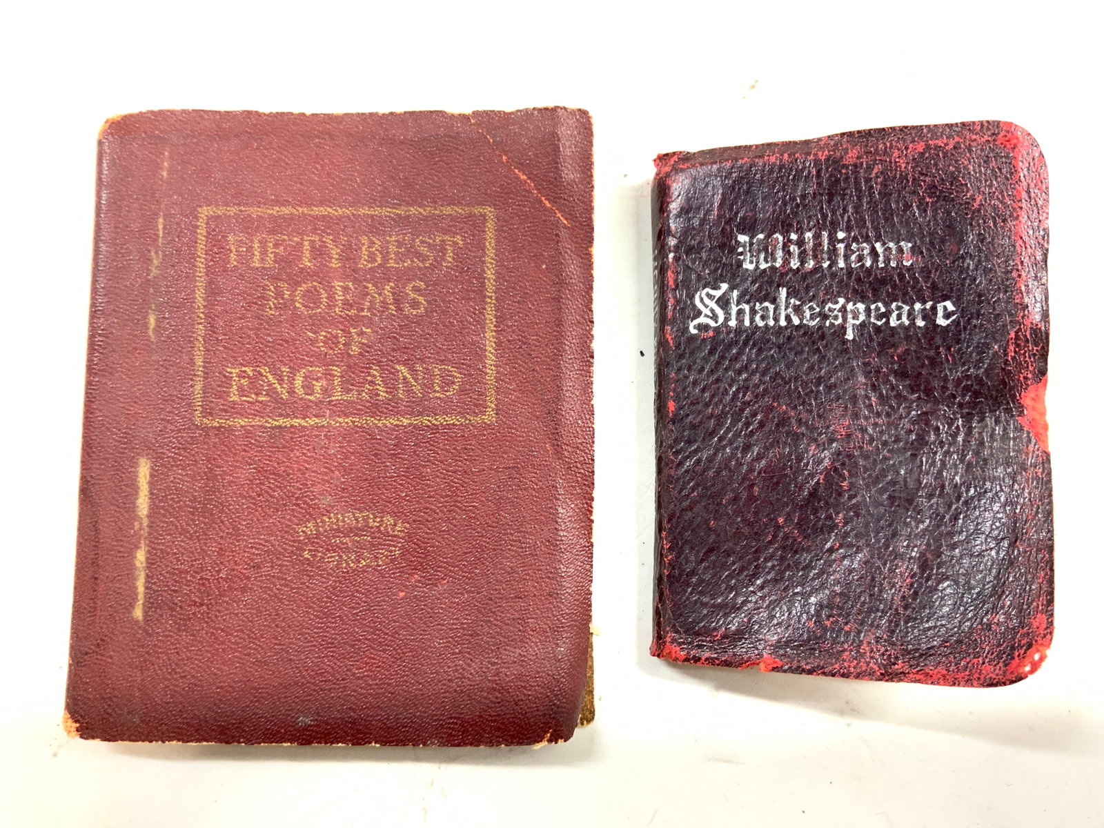 2 Antique Leather Shakespeare & Poetry Mini Books: Lot includes WILLIAM SHAKESPEARE & FIFTY BEST POEMS OF ENGLAND. Books appears to be antique possibly vintage. Each book has maroon toned leather cover. Largest book measures approximately 4 inches tal